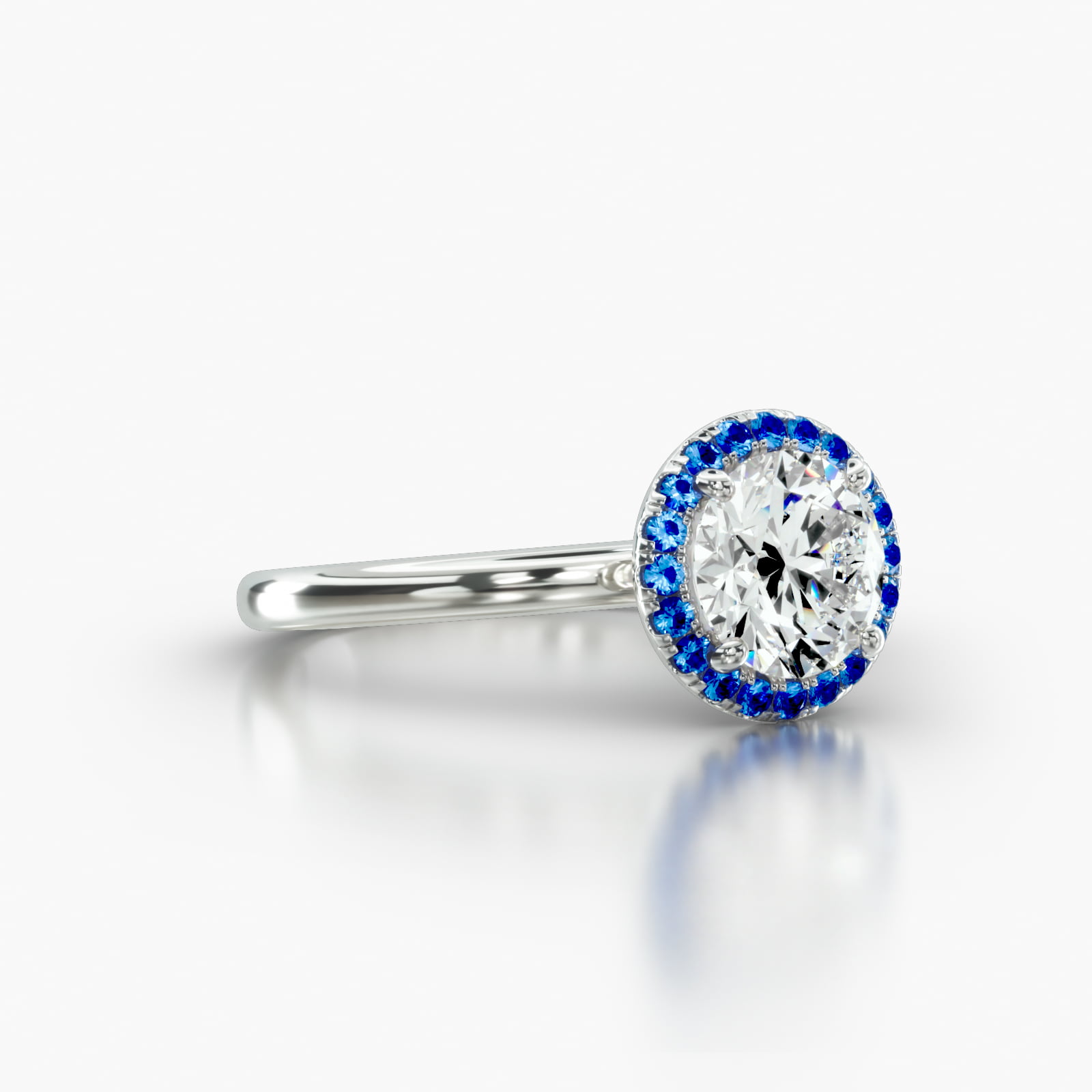 Solitaire Engagement Ring Embellished With a Single Row Sapphire Pavé Halo Head