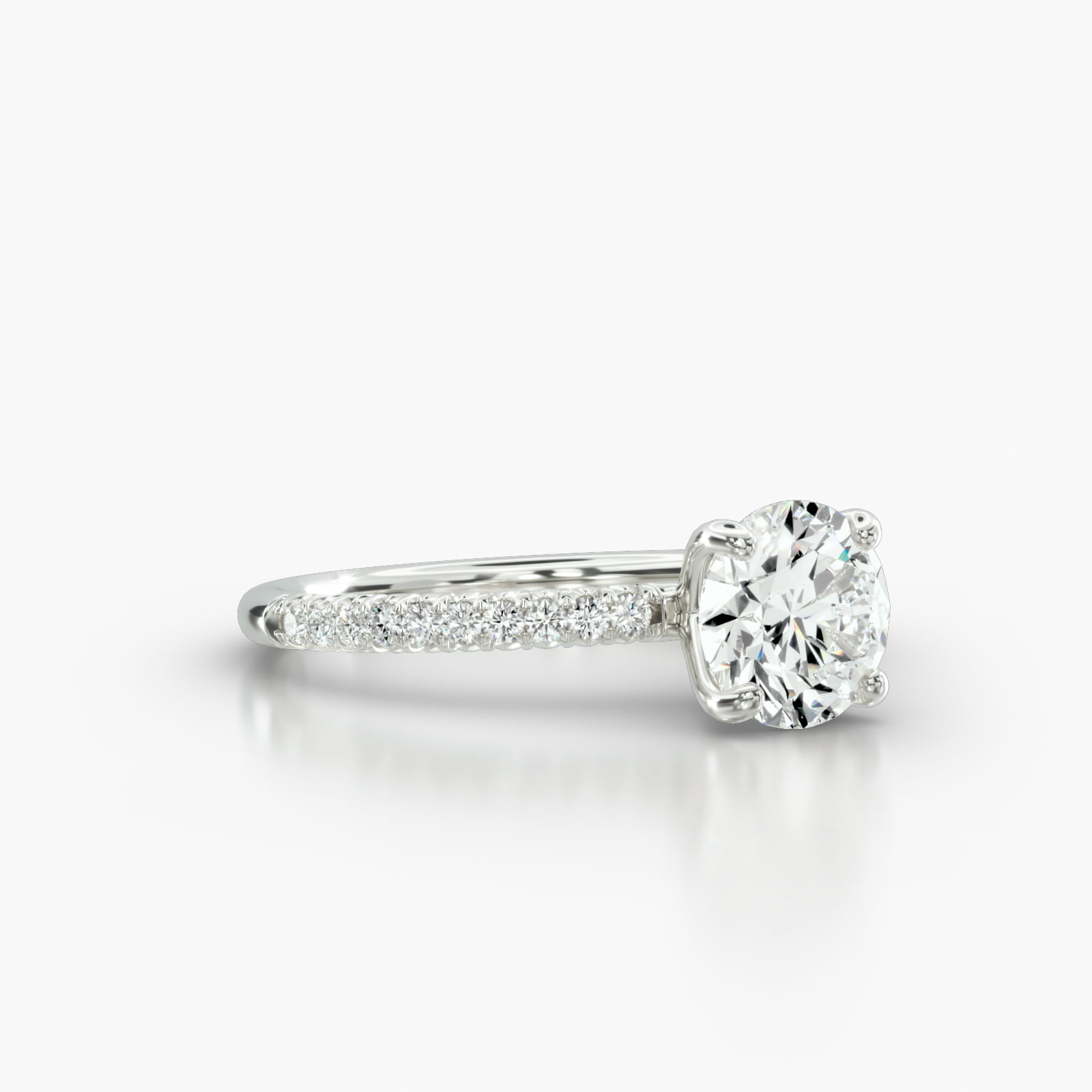 Petite French Pavé Engagement Ring Embellished With a Four Prong Signature Head With Diamond Bridge Accent