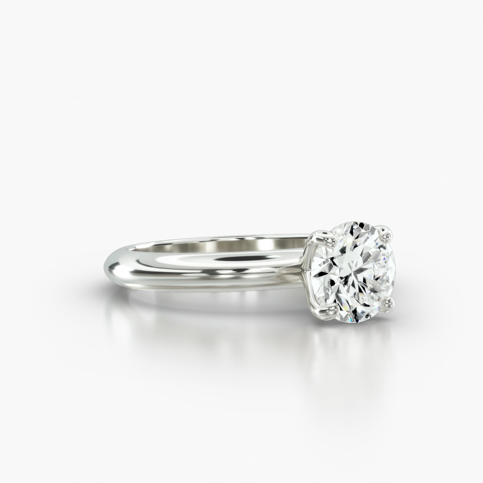 Knife Edge Solitaire Engagement Ring Embellished With a Four Prong Signature Head With Diamond Bridge Accent