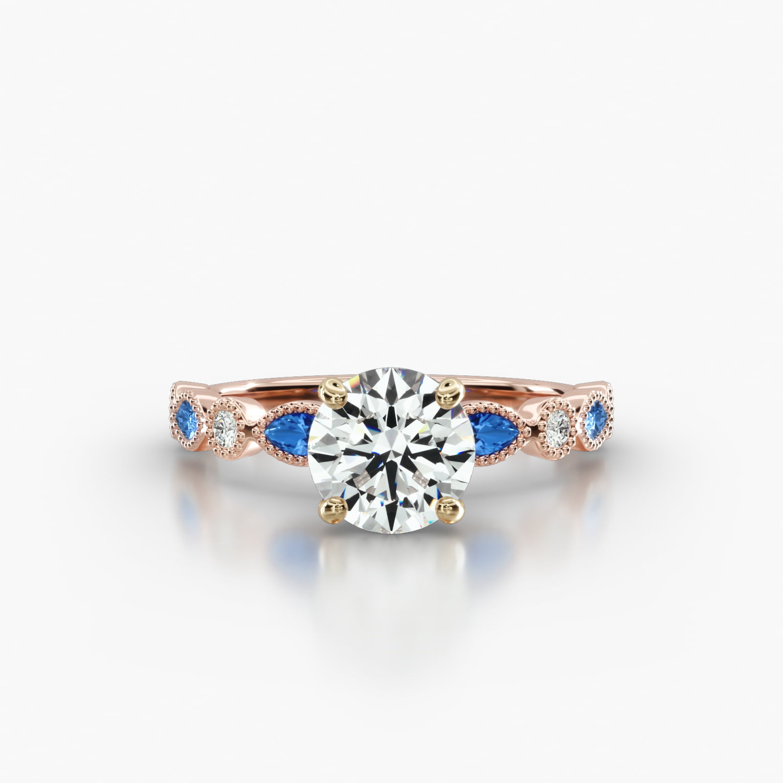 Round Diamond & Sapphire Marquise Shape Engagement Ring Embellished With a Four Prong Signature Head With Diamond Bridge Accent