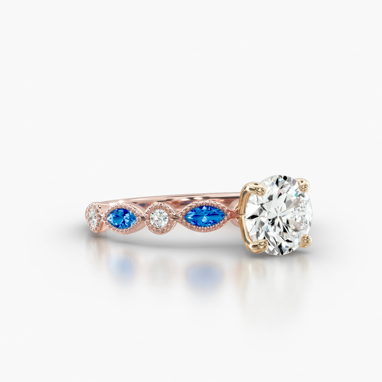 Round Diamond & Sapphire Marquise Shape Engagement Ring Embellished With a Four Prong Signature Head With Diamond Bridge Accent