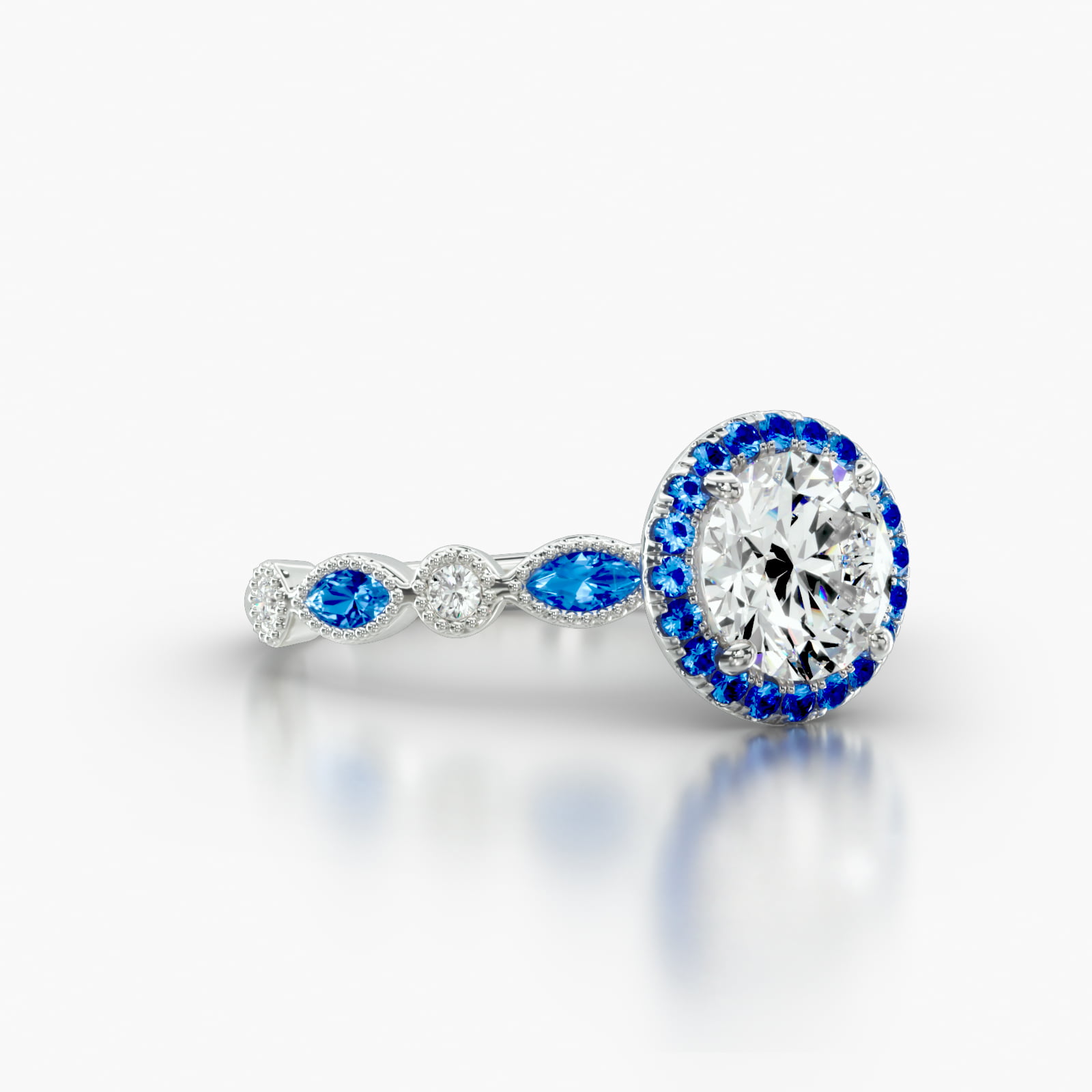Round Diamond & Sapphire Marquise Shape Engagement Ring Embellished With a Single Row Sapphire Pavé Halo Head