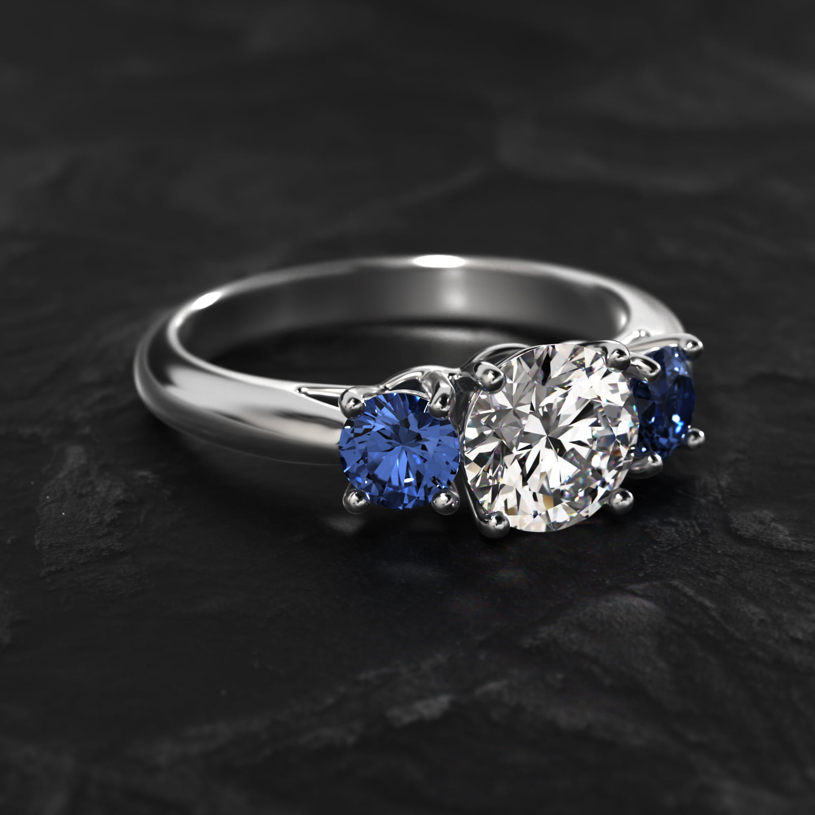 Round Blue Sapphire Three Stone Engagement Ring In 18K White Gold