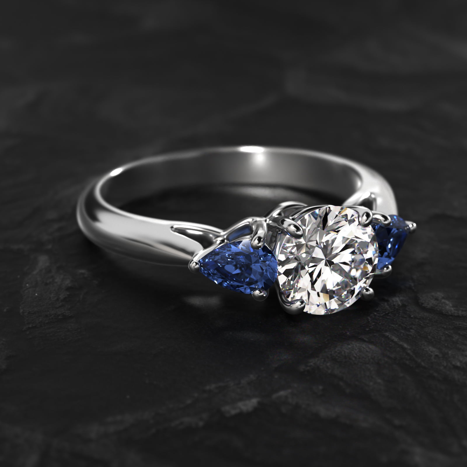 Pear Shaped Blue Sapphire Three Stone Engagement Ring In Platinum