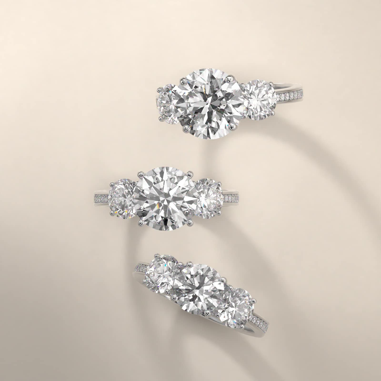 Round Diamond Three Stone Engagement Ring With Pavé Set Diamonds In Platinum