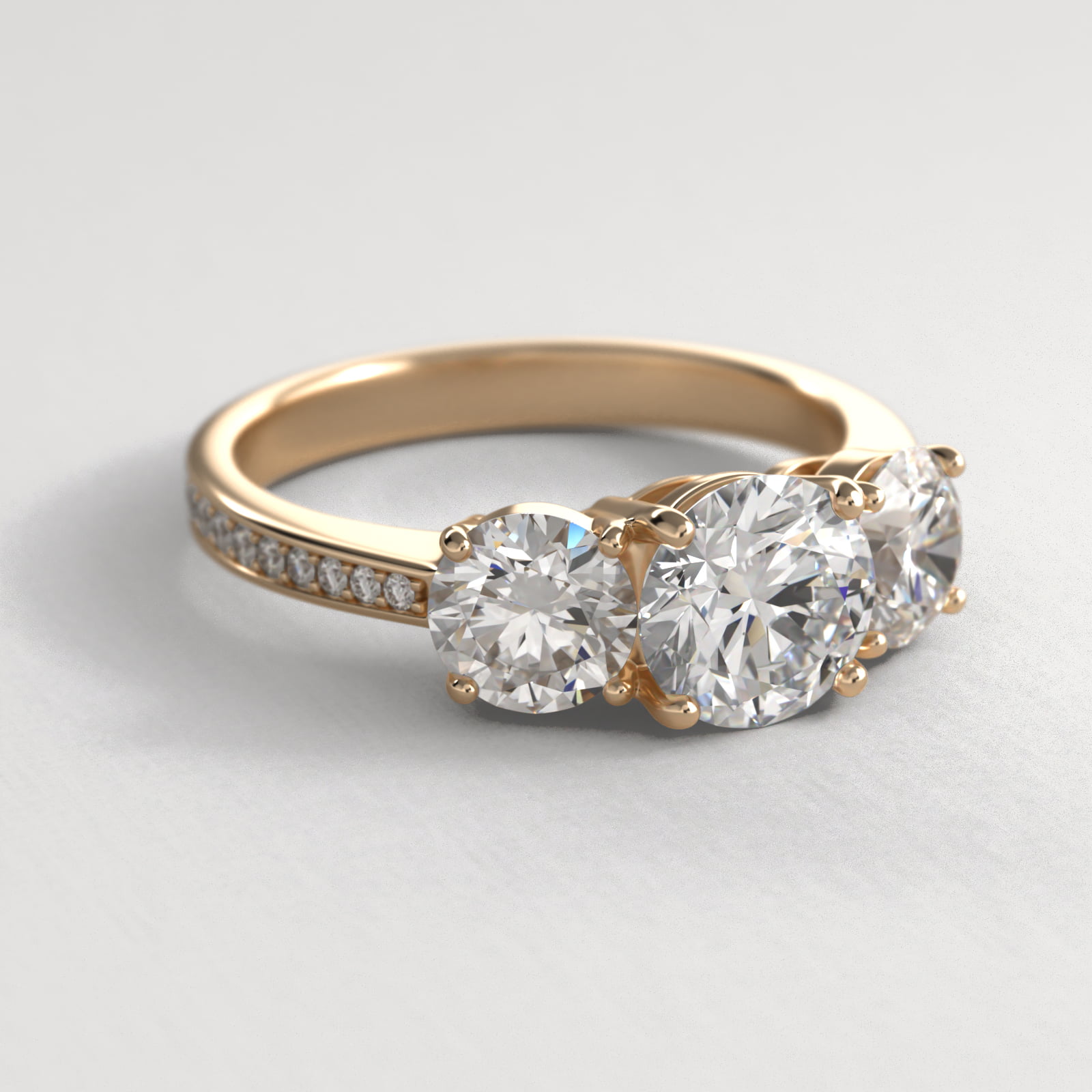 Round Diamond Three Stone Engagement Ring With Pavé Set Diamonds In 14K Yellow Gold