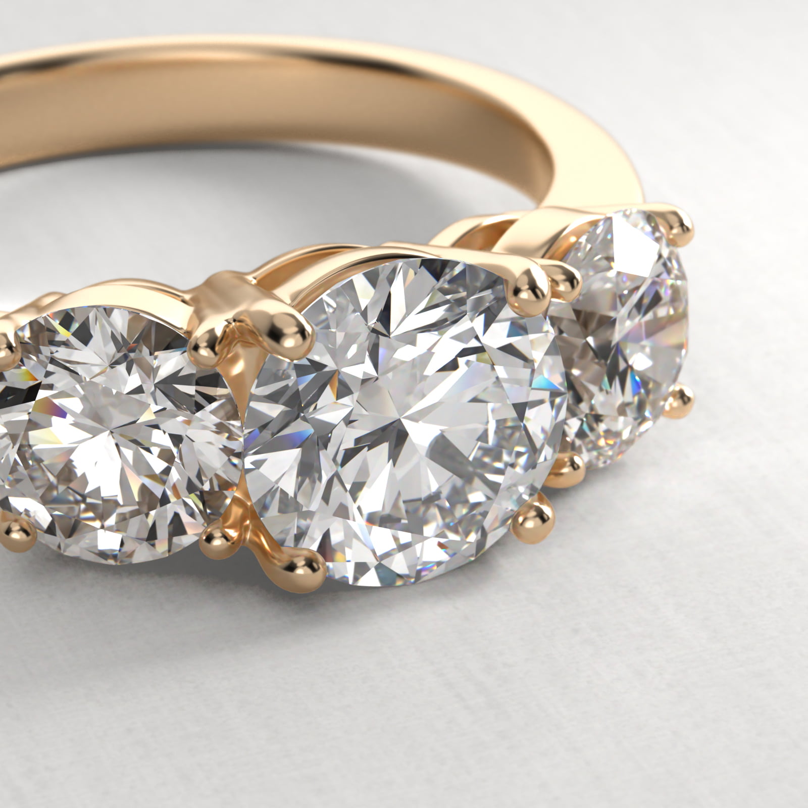 Round Diamond Three Stone Engagement Ring With Pavé Set Diamonds In 18K Yellow Gold