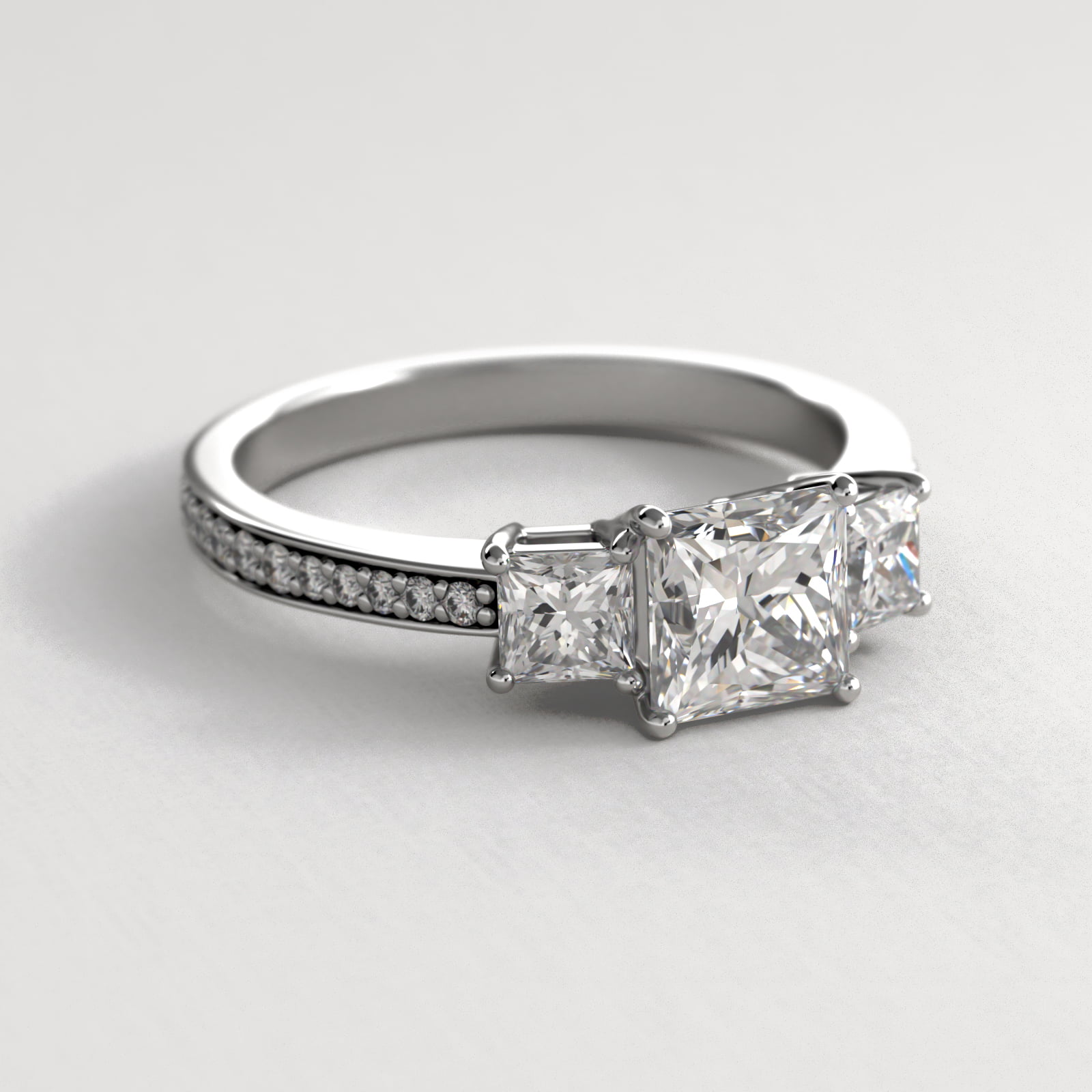 Princess Cut Diamond Three Stone Engagement Ring With Pavé Set Diamonds In 14K White Gold