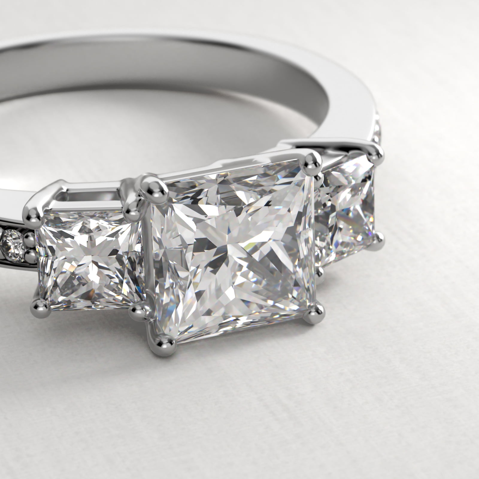Princess Cut Diamond Three Stone Engagement Ring With Pavé Set Diamonds In 18K White Gold