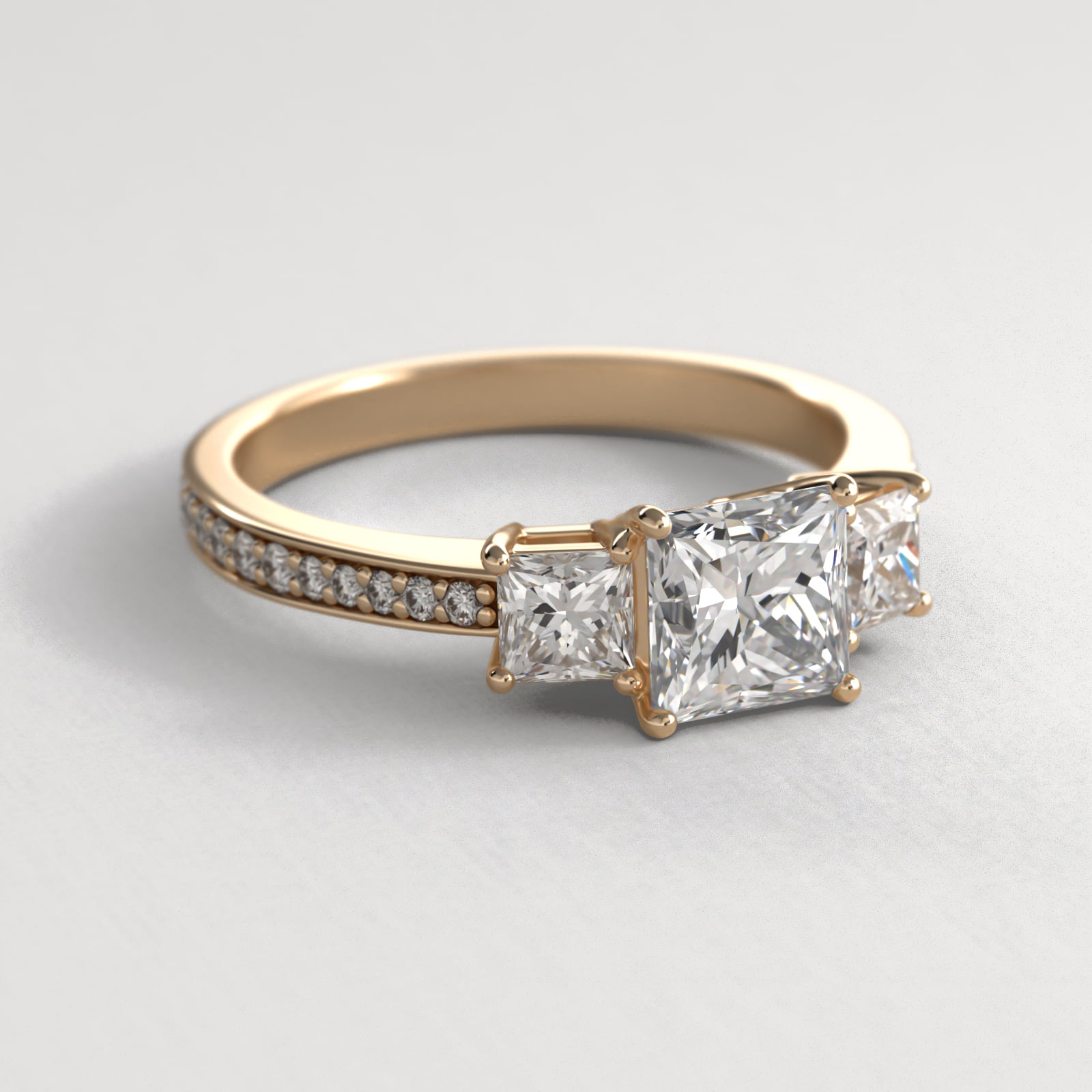 Princess Cut Diamond Three Stone Engagement Ring With Pavé Set Diamonds In 18K Yellow Gold