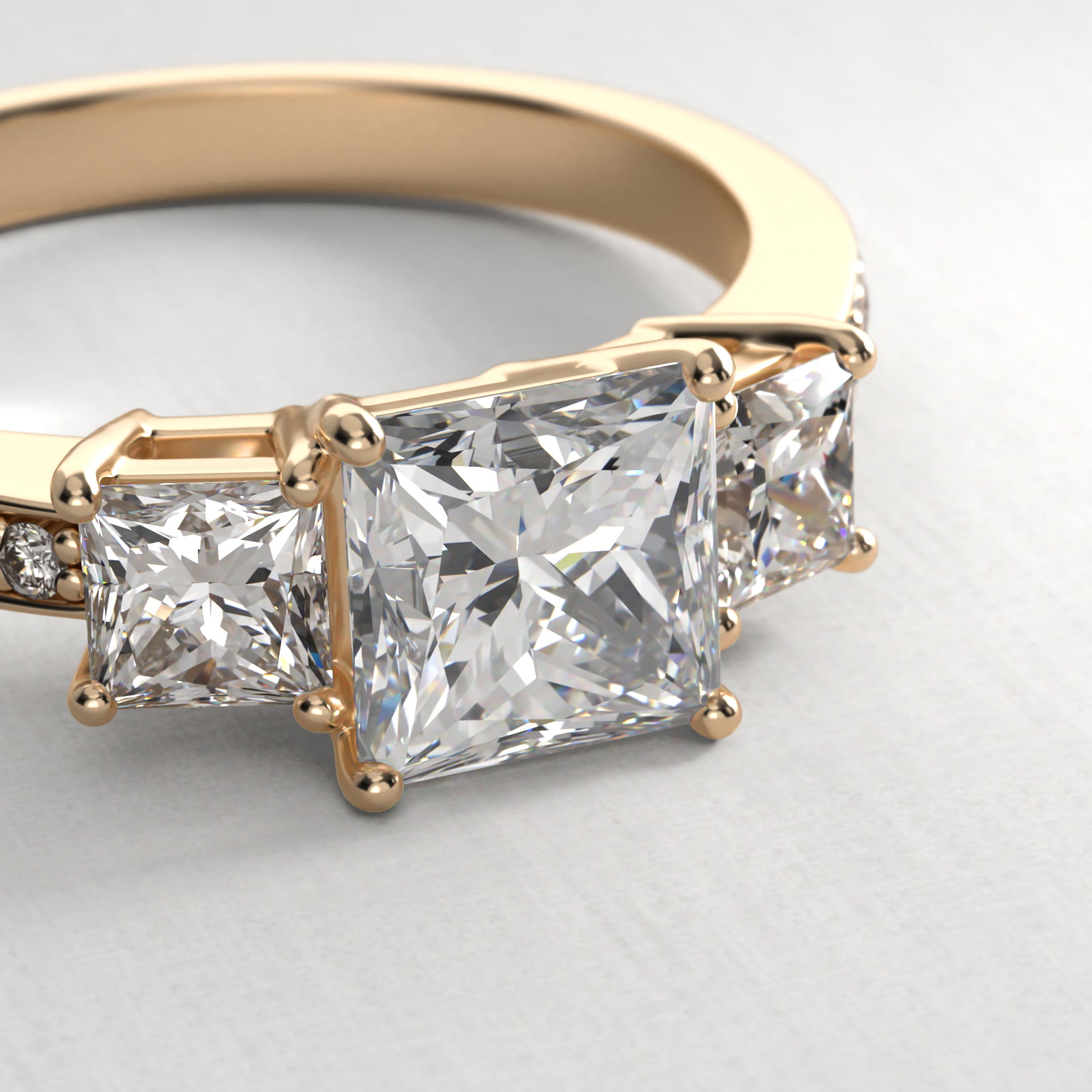Princess Cut Diamond Three Stone Engagement Ring With Pavé Set Diamonds In 18K Yellow Gold