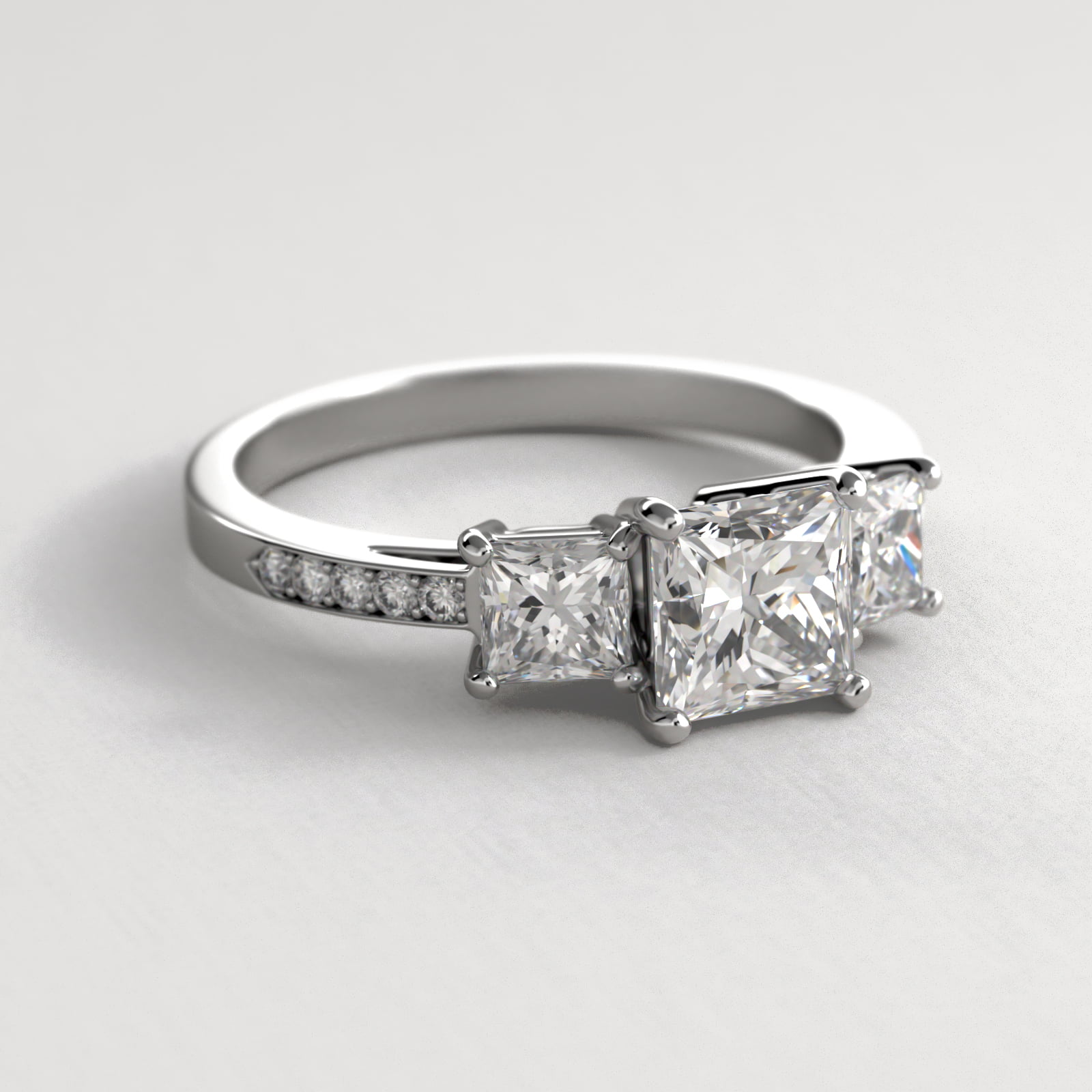 Princess Cut Diamond Three Stone Engagement Ring With Pavé Set Diamonds In 14K White Gold