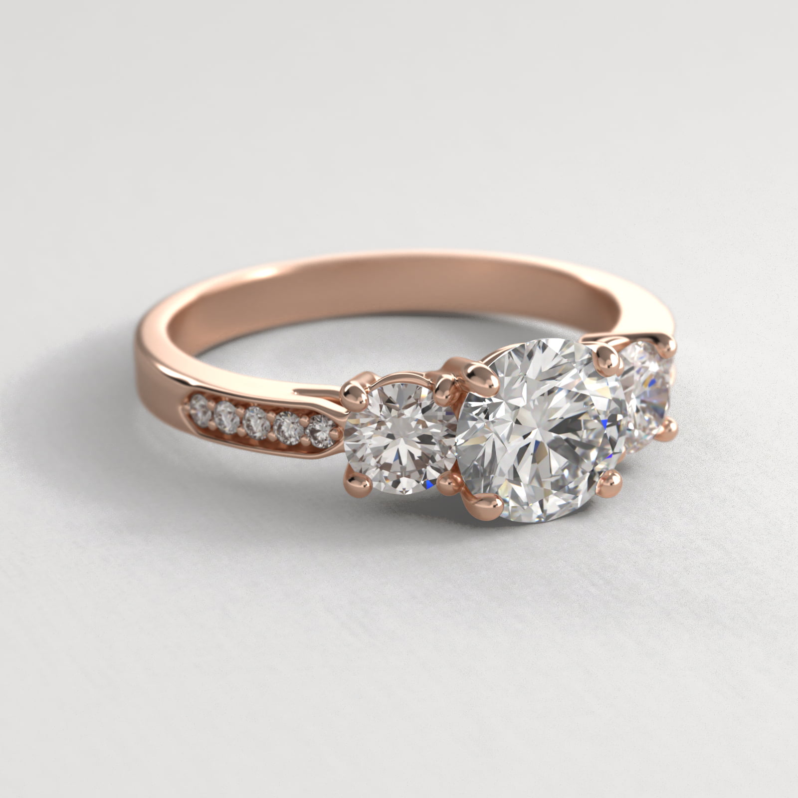 Round Diamond Three Stone Engagement Ring With Pavé Set Diamonds In 14K Rose Gold