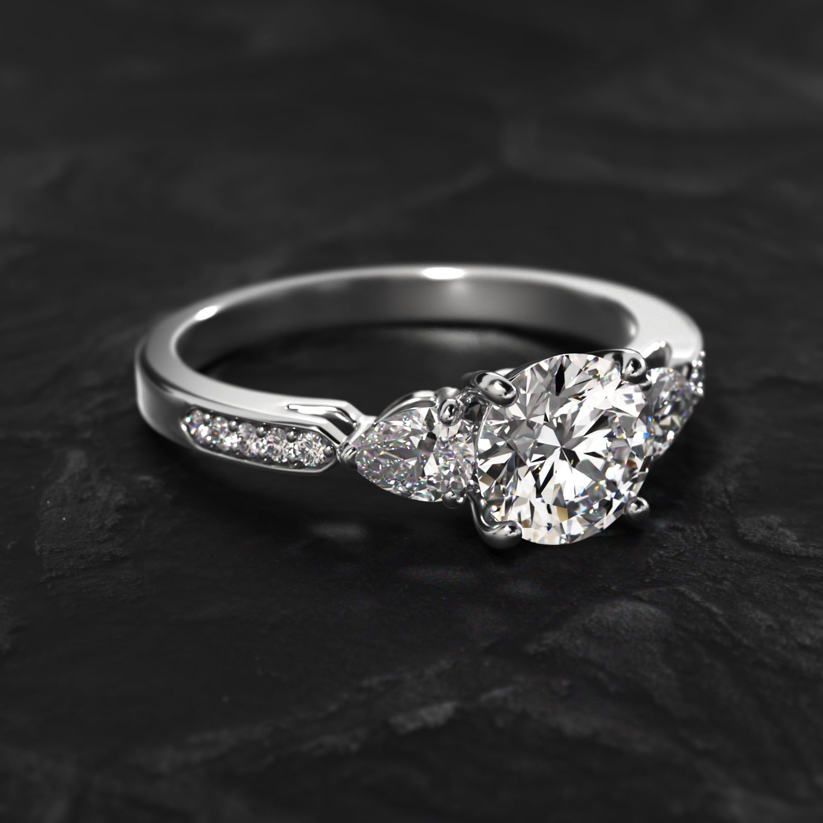 Pear Shaped Diamond Three Stone Engagement Ring With Pavé Set Diamonds In 14K White Gold