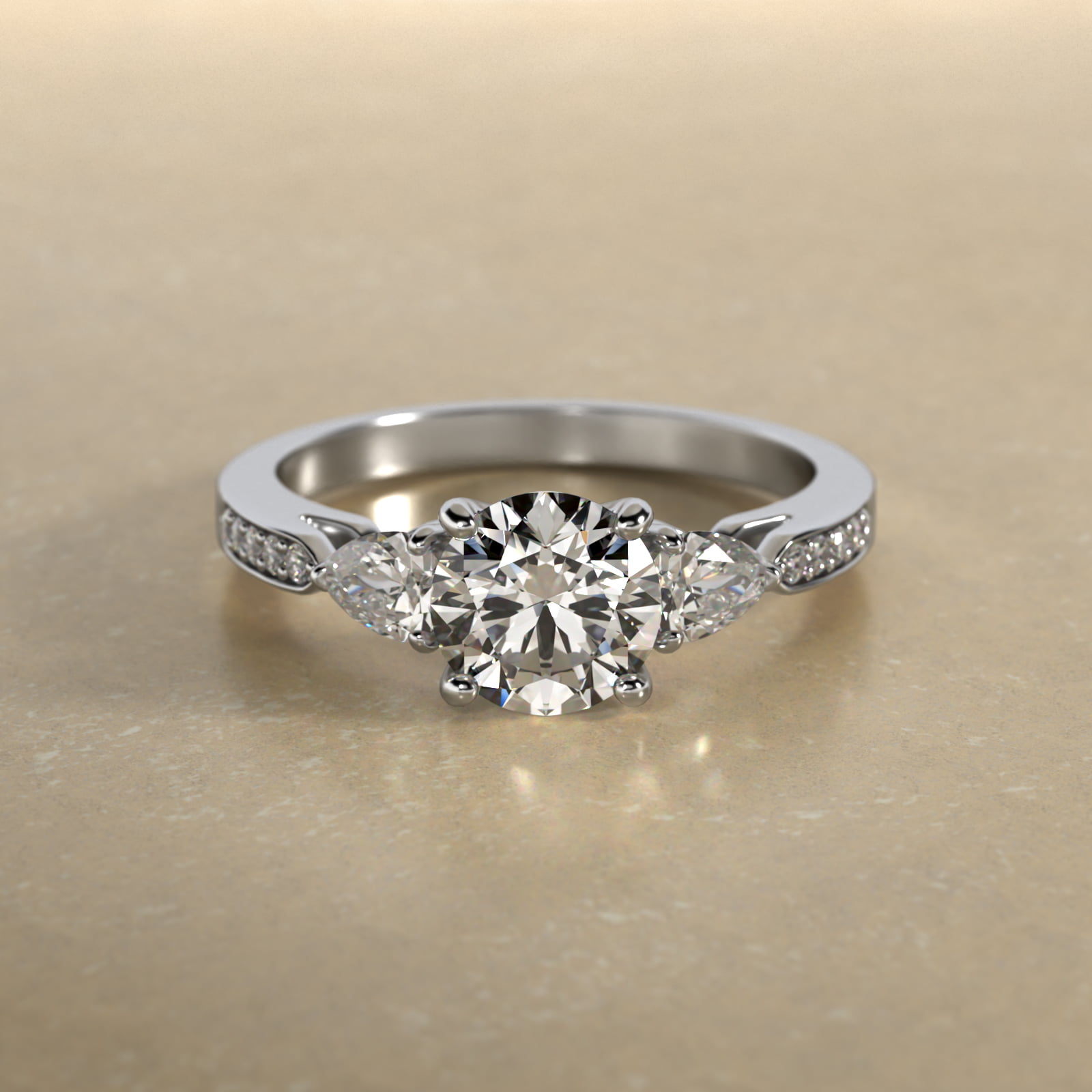 Pear Shaped Diamond Three Stone Engagement Ring With Pavé Set Diamonds In Platinum