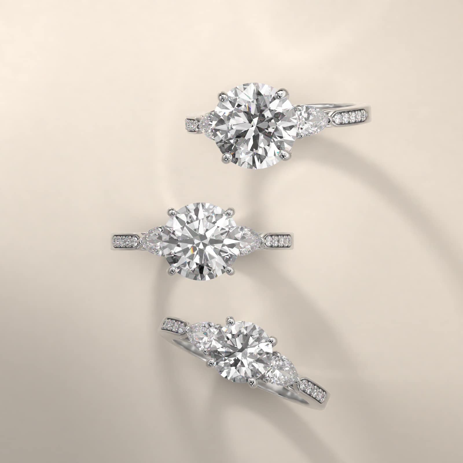 Pear Shaped Diamond Three Stone Engagement Ring With Pavé Set Diamonds In 18K White Gold