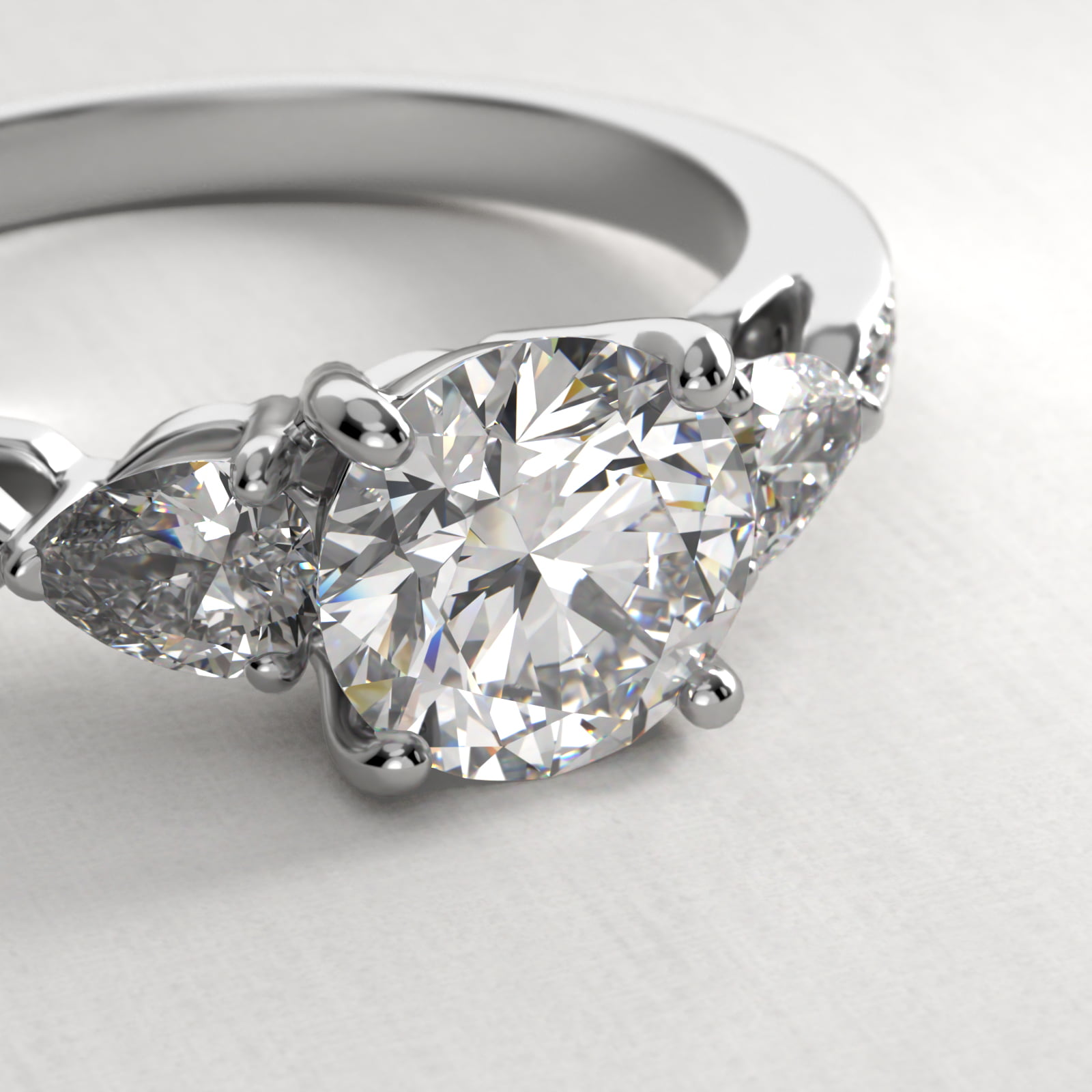 Pear Shaped Diamond Three Stone Engagement Ring With Pavé Set Diamonds In 14K White Gold