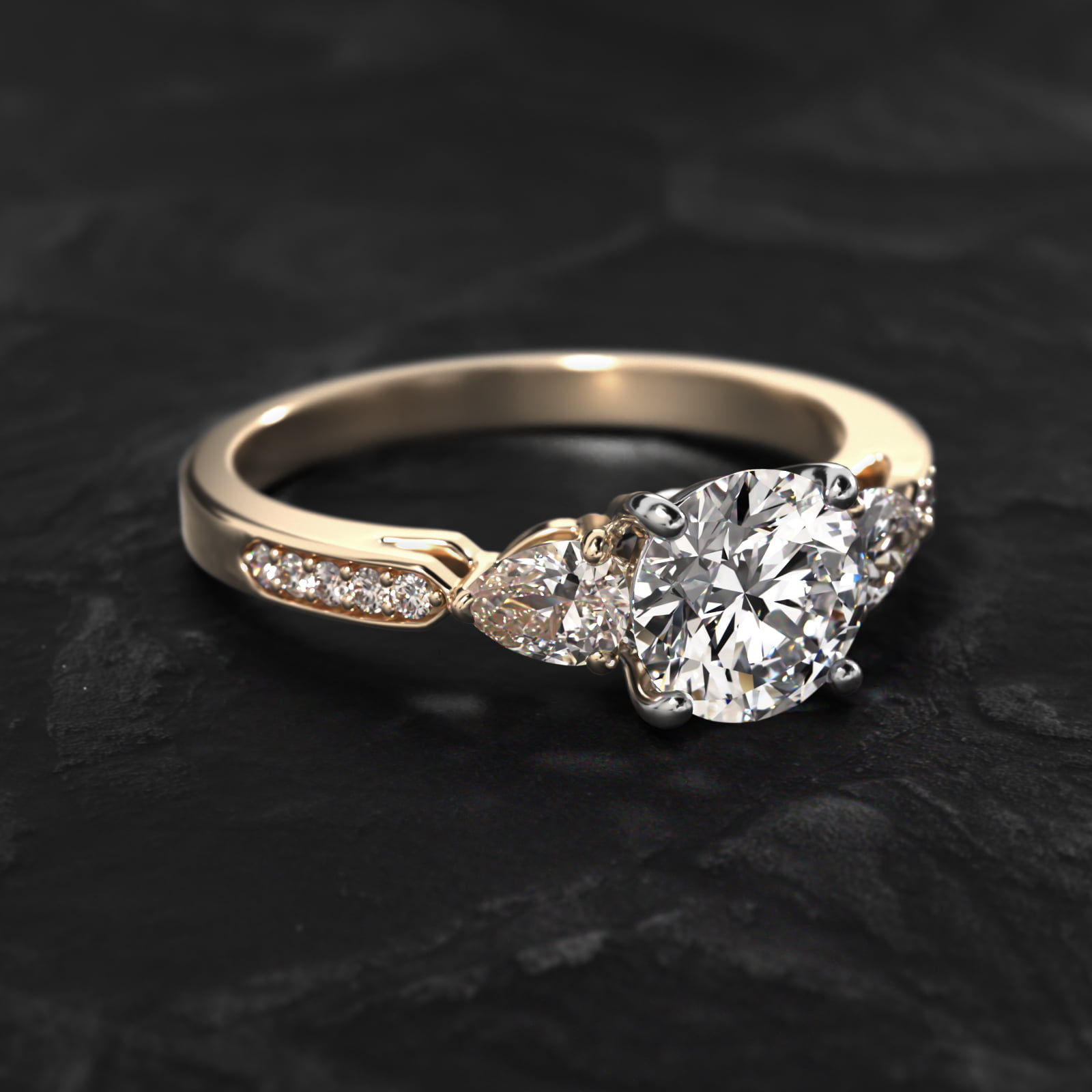 Pear Shaped Diamond Three Stone Engagement Ring With Pavé Set Diamonds In 18K Yellow Gold