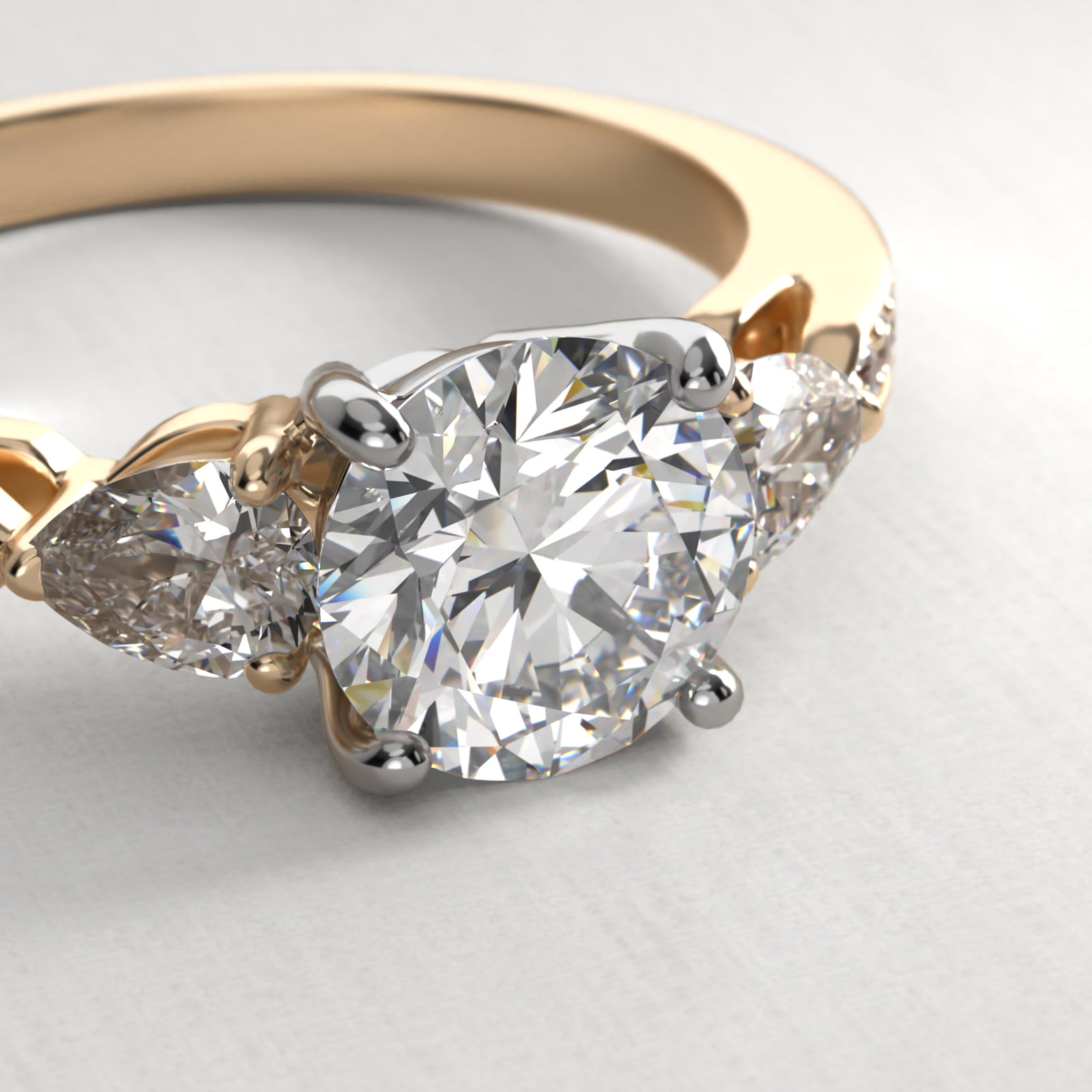 Pear Shaped Diamond Three Stone Engagement Ring With Pavé Set Diamonds In 14K Yellow Gold