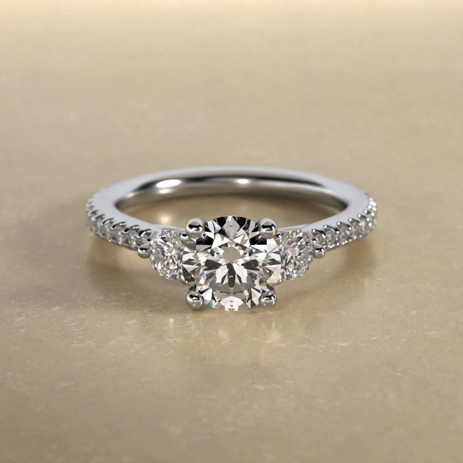 Round Diamond Three Stone Engagement Ring With Cross Prong And Pavé Set Diamonds In Platinum