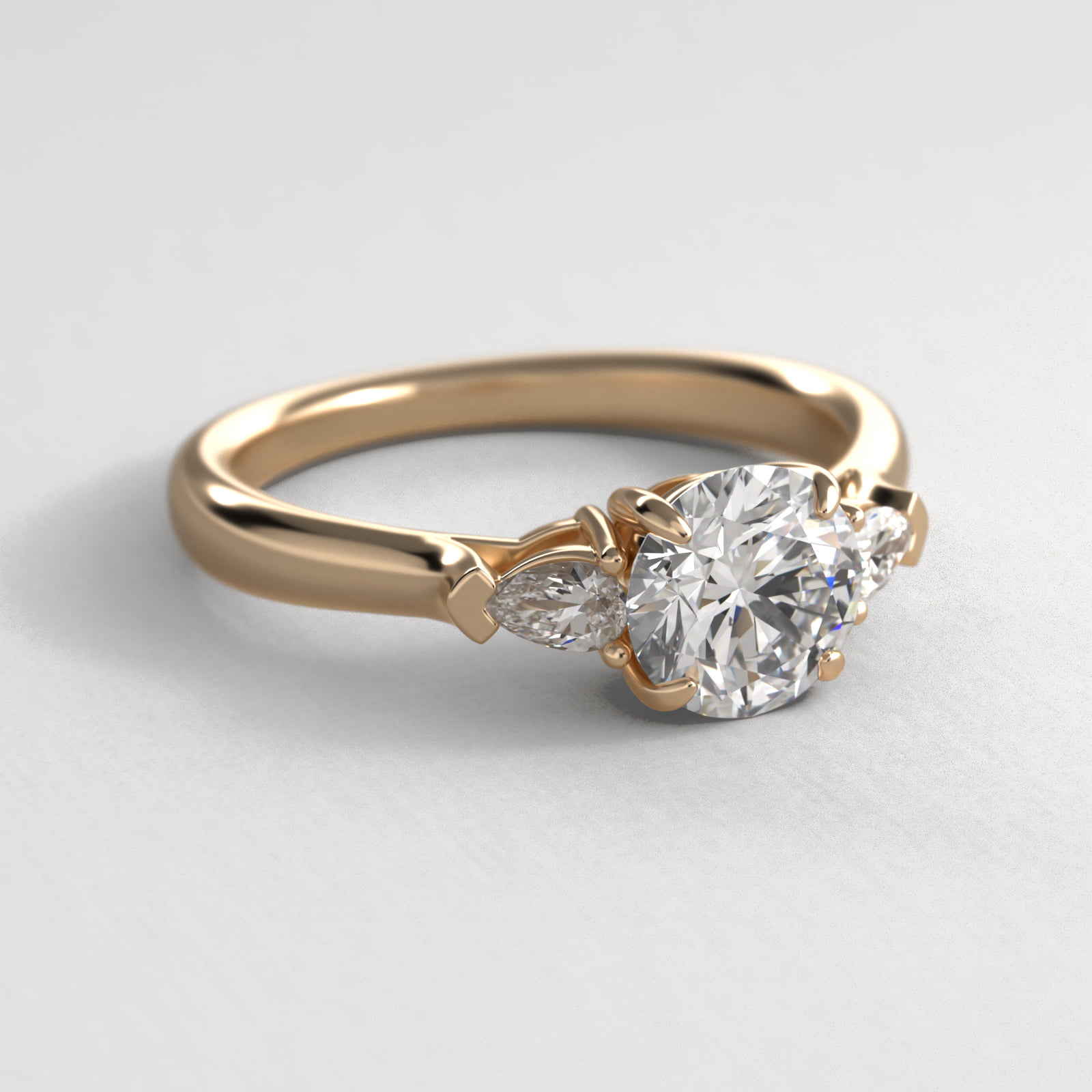 Pear Shaped Diamond Three Stone Engagement Ring In 18K Yellow Gold