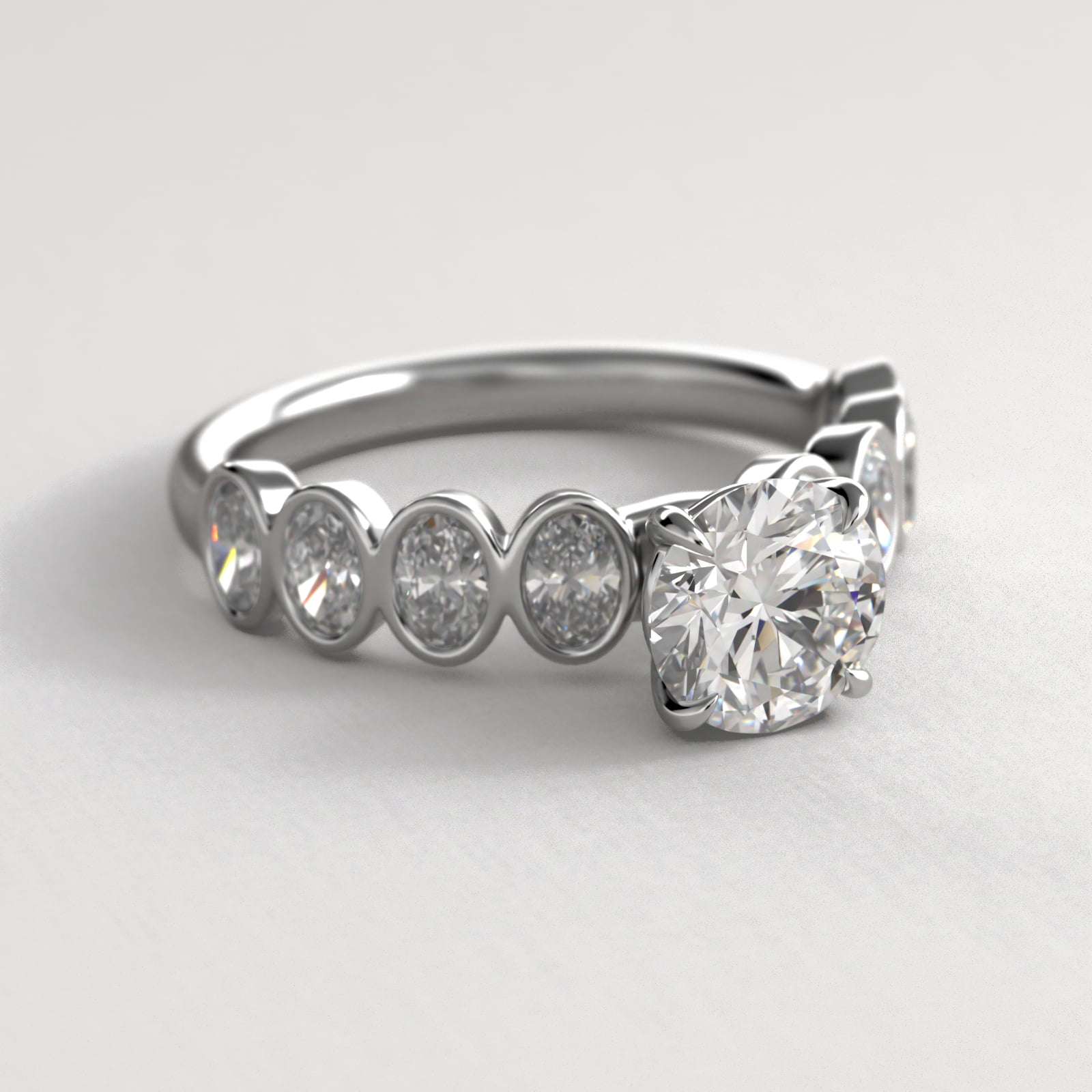 Bezel Set Oval Cut Side Stone Diamond Engagement Ring In 18K White Gold