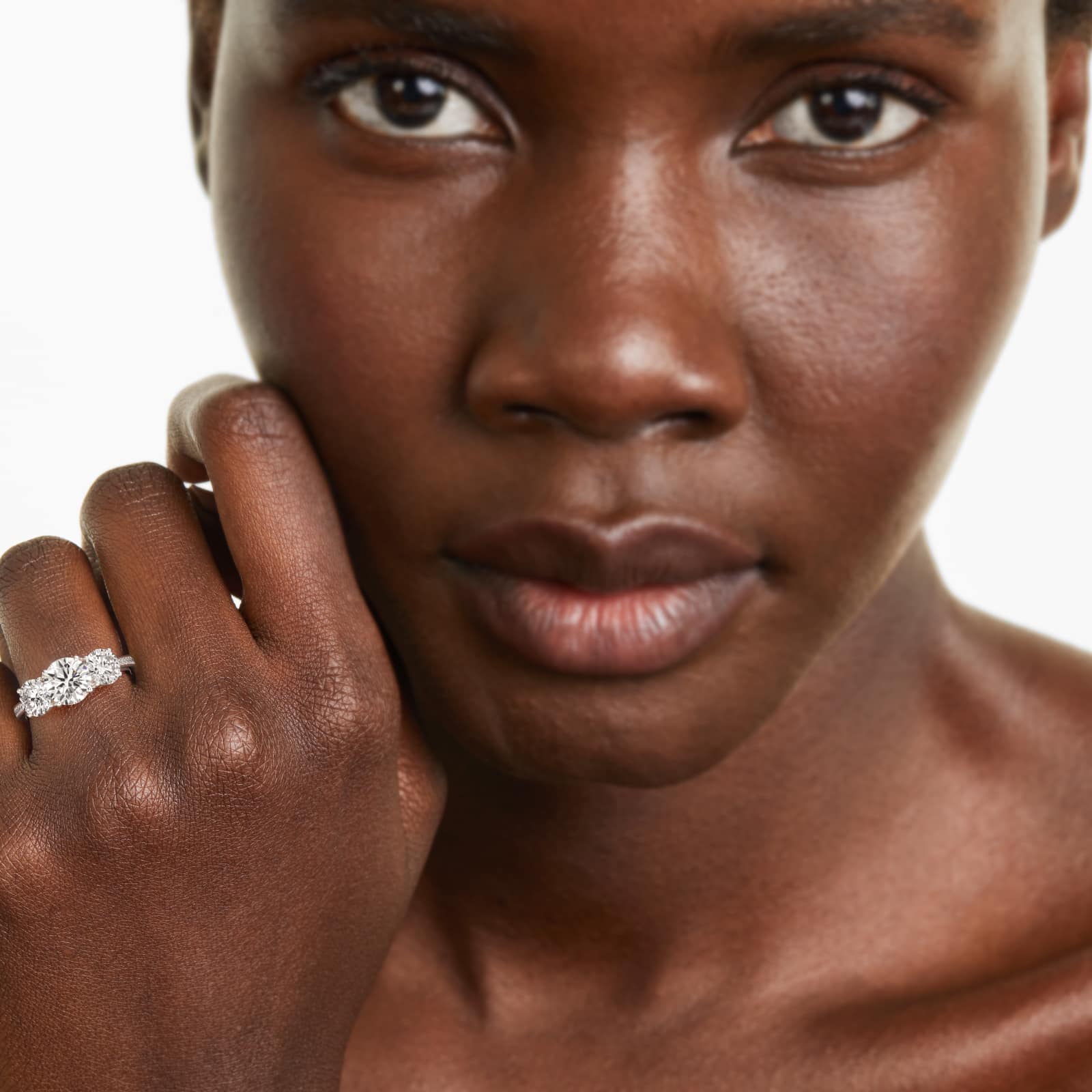 Round Diamond Three Stone Engagement Ring With Pavé Set Diamonds In Platinum