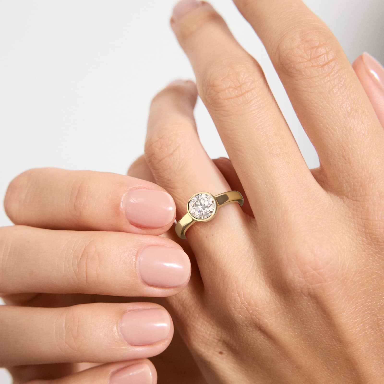 Bezel Set Round Solitaire Engagement Ring In 14K Yellow Gold