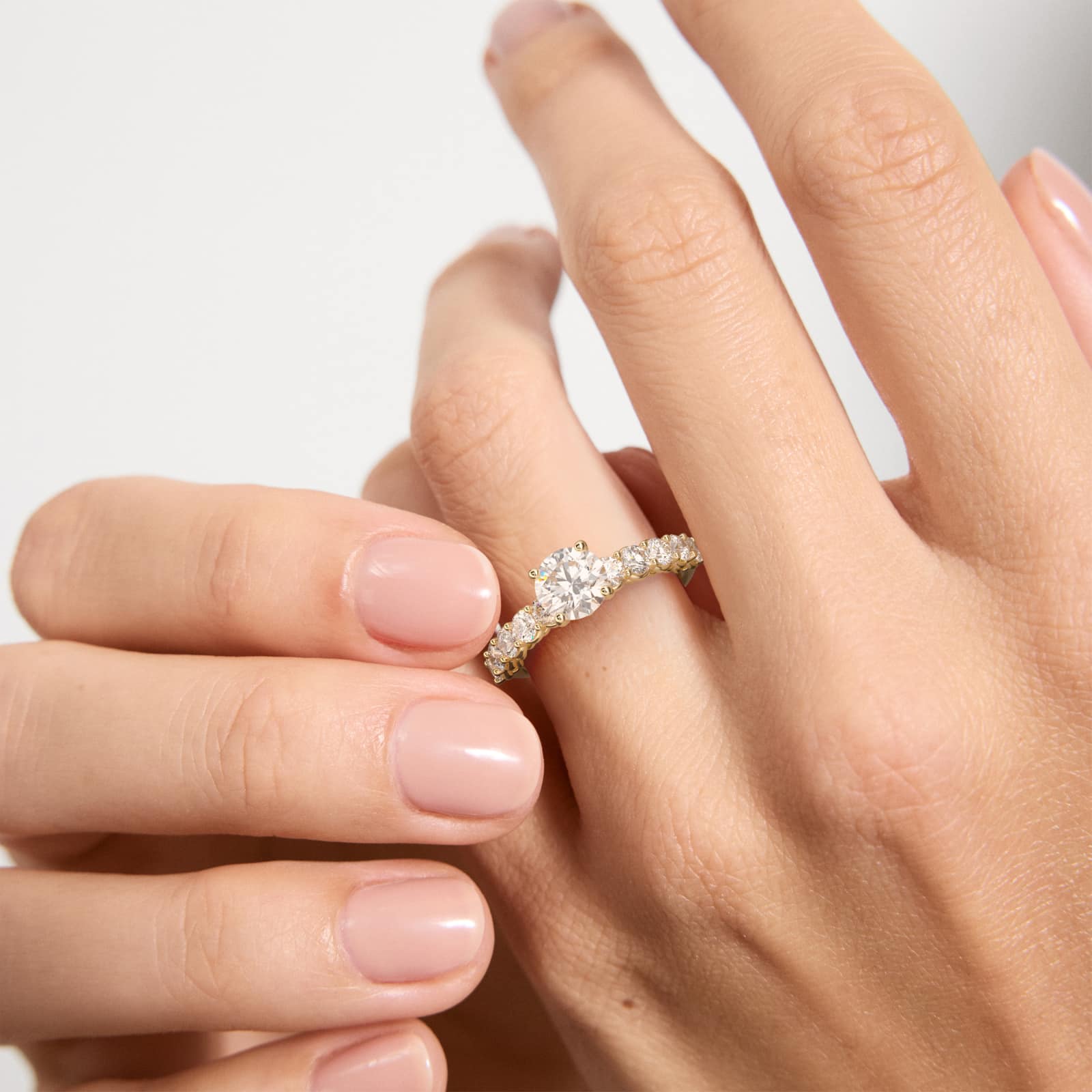 Prong Set Side Stone Diamond Engagement Ring In 14K Yellow Gold