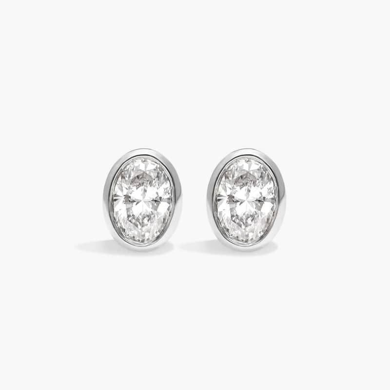 Bezel Diamond Stud Earrings With 0.25 CTW Oval Cut Diamonds in 14K White Gold