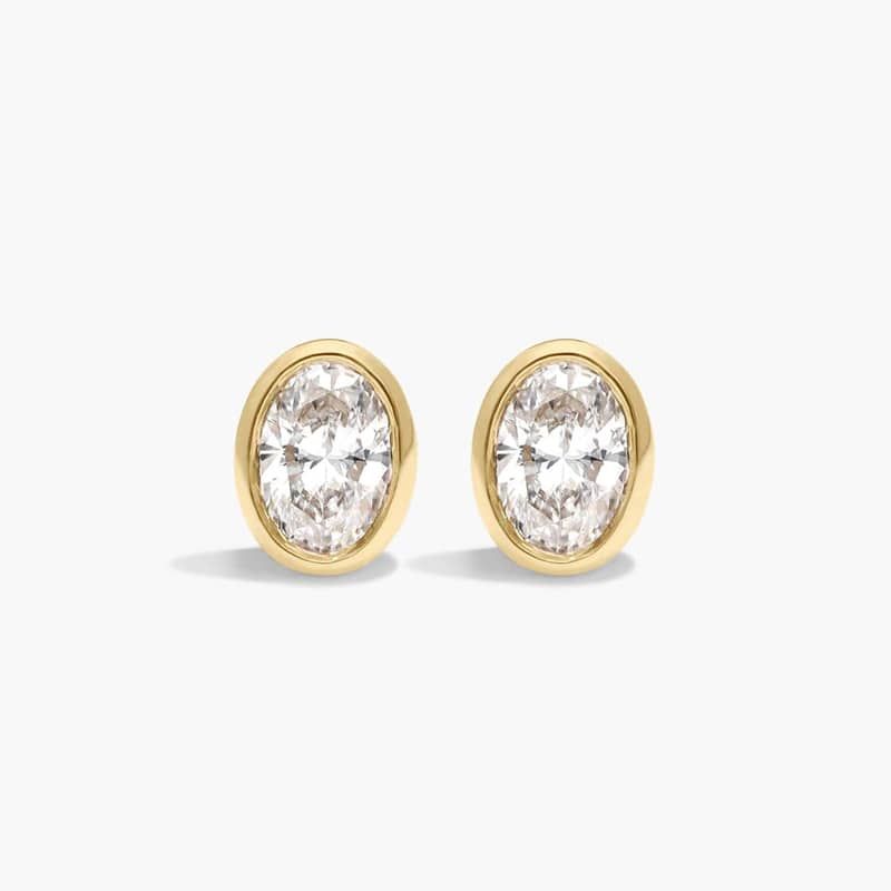 Bezel Diamond Stud Earrings With 0.25 CTW Oval Cut Diamonds in 14K Yellow Gold