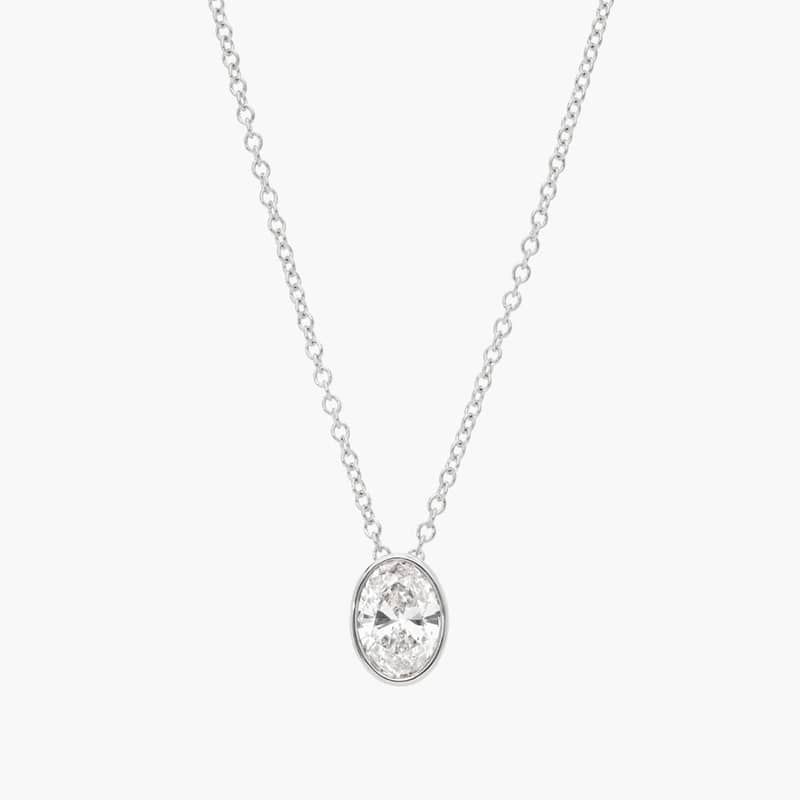 Bezel Solitaire Pendant Necklace With 0.75 CTW Oval Cut Diamond in Platinum