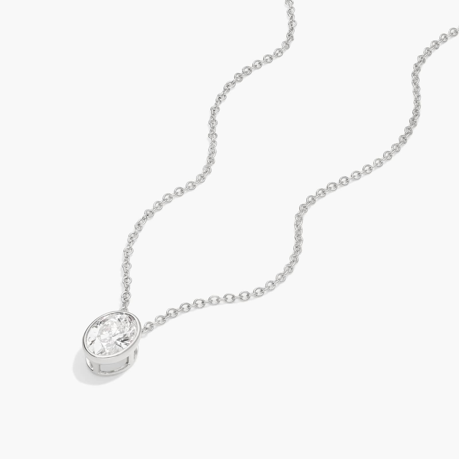 Bezel Solitaire Pendant Necklace With 0.75 CTW Oval Cut Diamond in Platinum