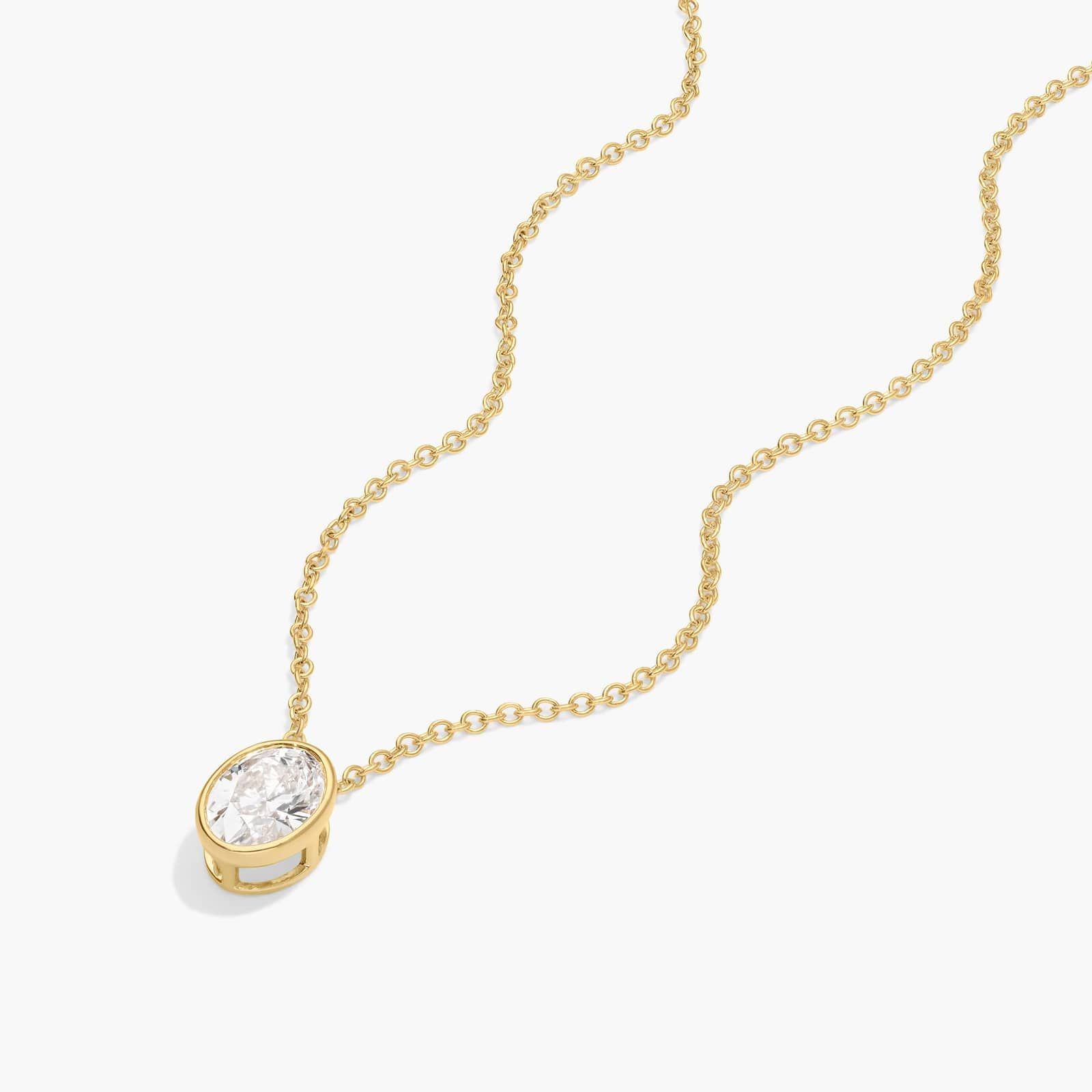 Bezel Solitaire Pendant Necklace With 0.75 CTW Oval Cut Diamond in 14K Yellow Gold