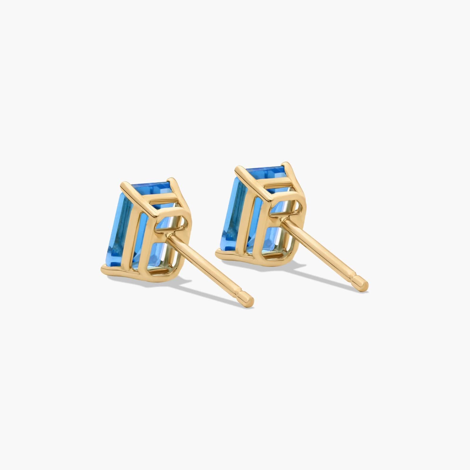 Emerald Cut Swiss Blue Topaz Birthstone Stud Earrings In 14K Yellow Gold