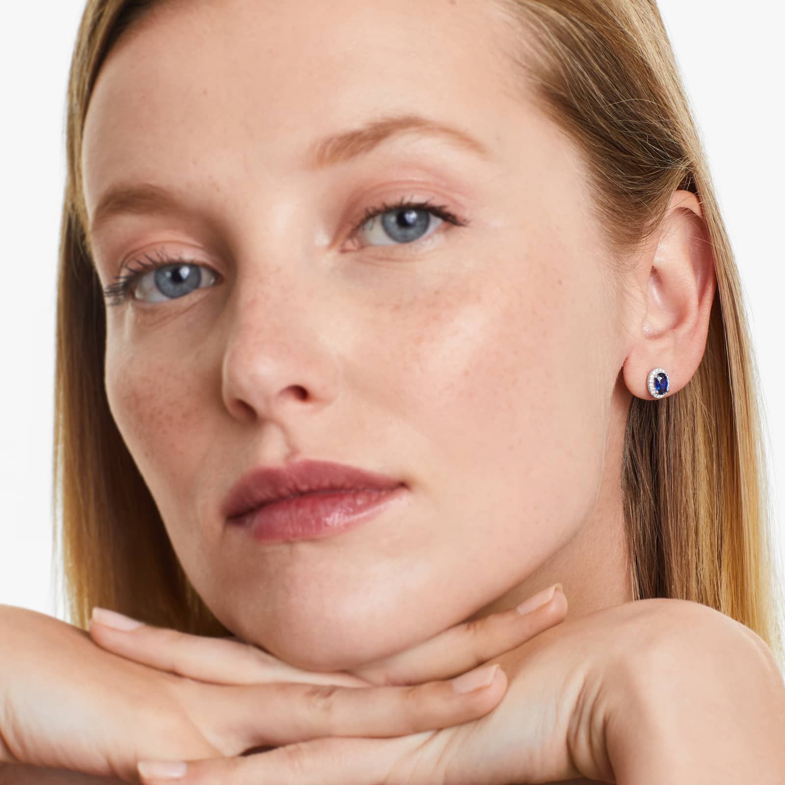 Oval Cut Sapphire And Diamond Halo Earrings In 18K White Gold