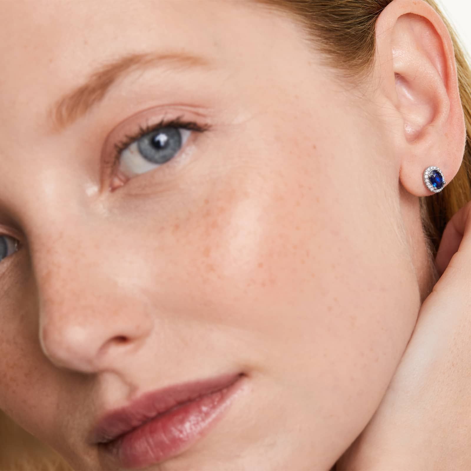 Oval Cut Sapphire And Diamond Halo Earrings In 18K White Gold