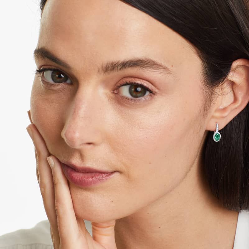 Petite Oval Cut Emerald And Diamond Halo Drop Earrings In 18K White Gold