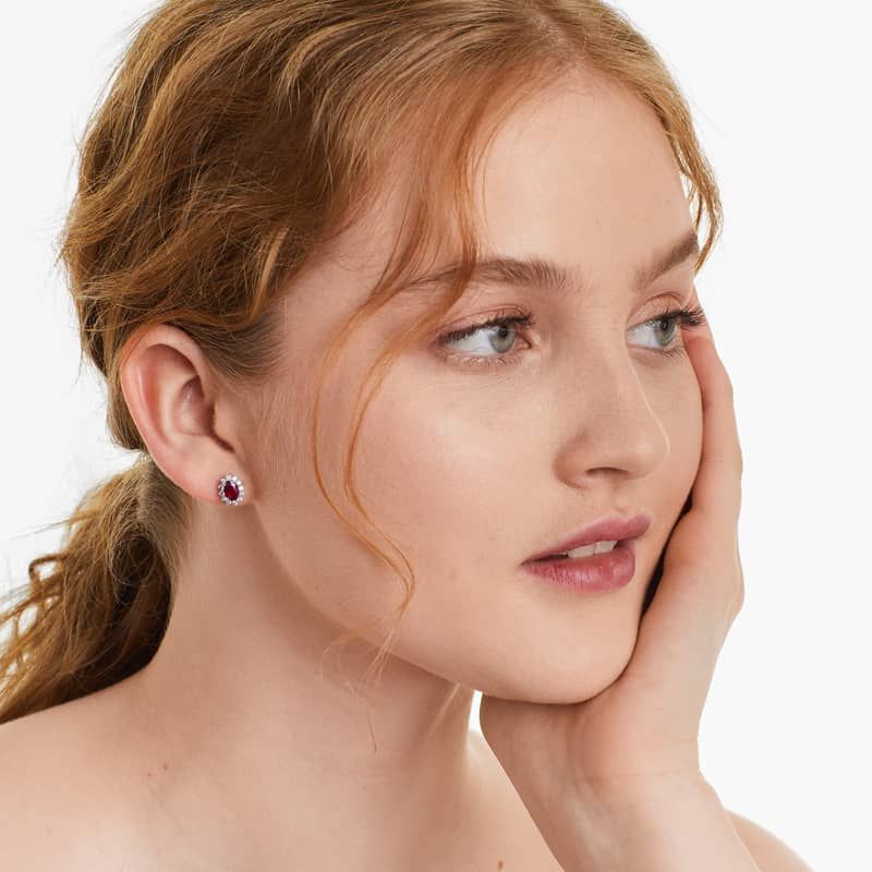 Oval Cut Ruby And Diamond Halo Earrings In 18K White Gold