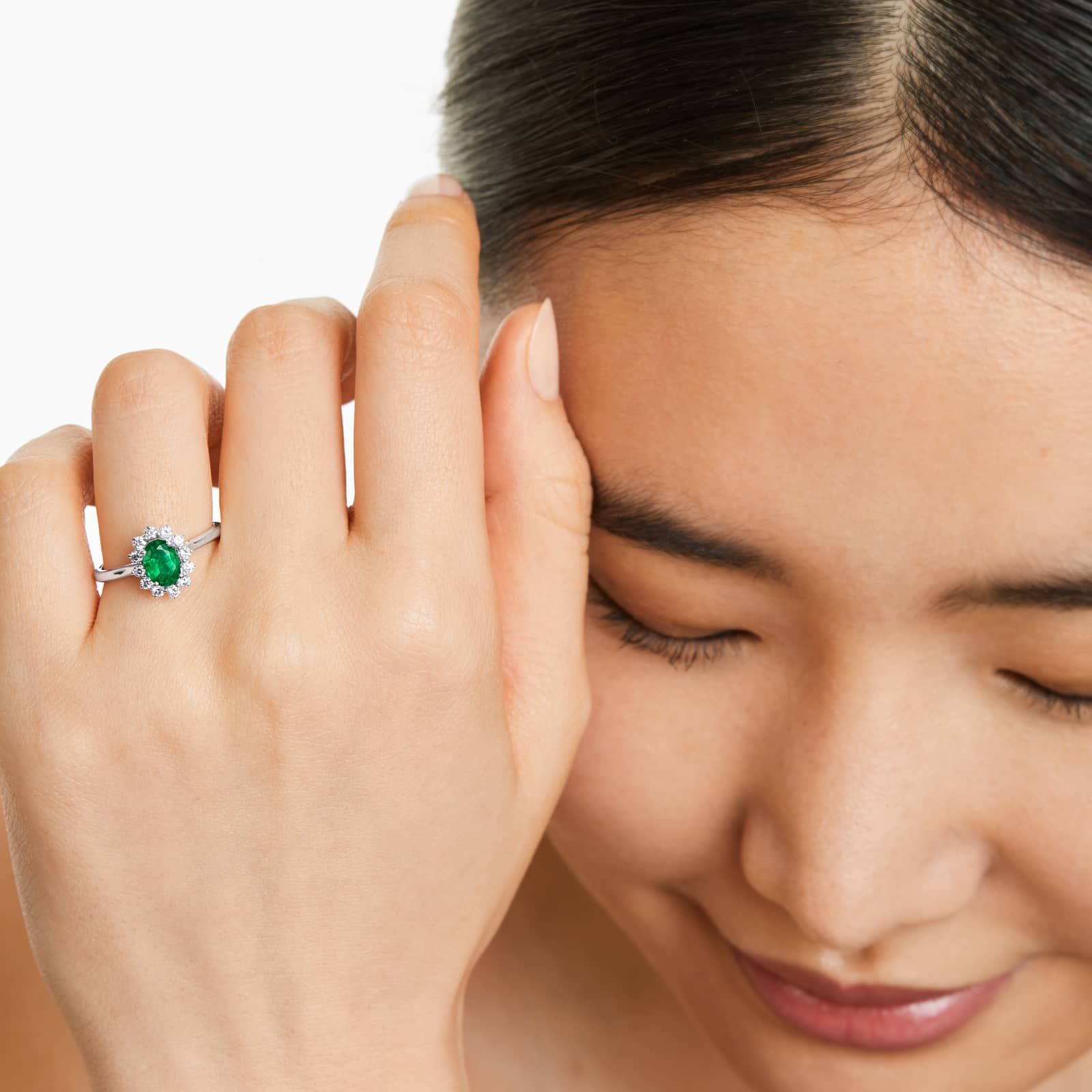 Oval Halo Emerald And Diamond Ring In 18K White Gold