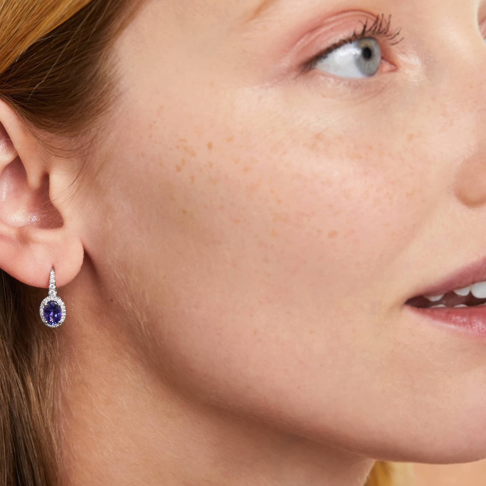 Oval Cut Tanzanite And Diamond Halo Drop Earrings In 14K White Gold