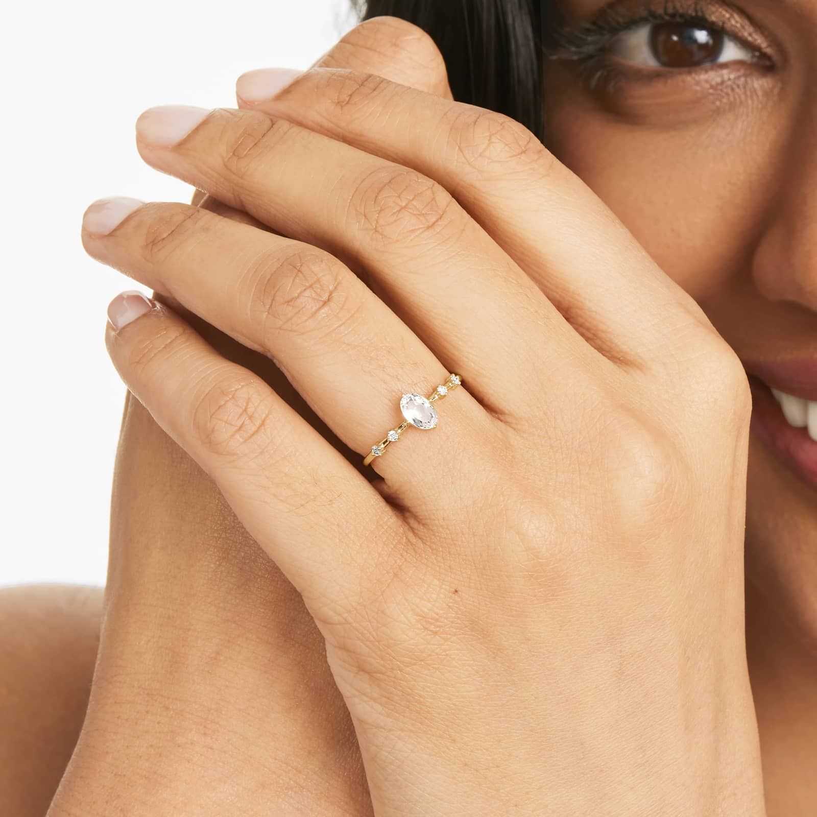 Oval White Topaz And Diamond Birthstone Ring In 14K Yellow Gold