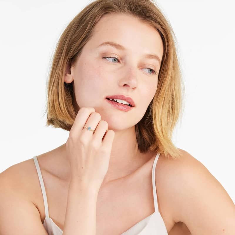 Oval Blue Topaz And Diamond Birthstone Ring In 14K Yellow Gold