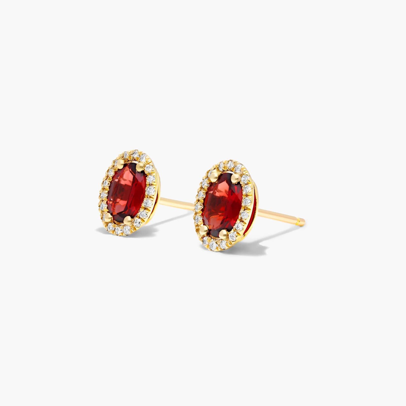 Oval Cut Garnet And Diamond Halo Stud Earrings In 14K Yellow Gold