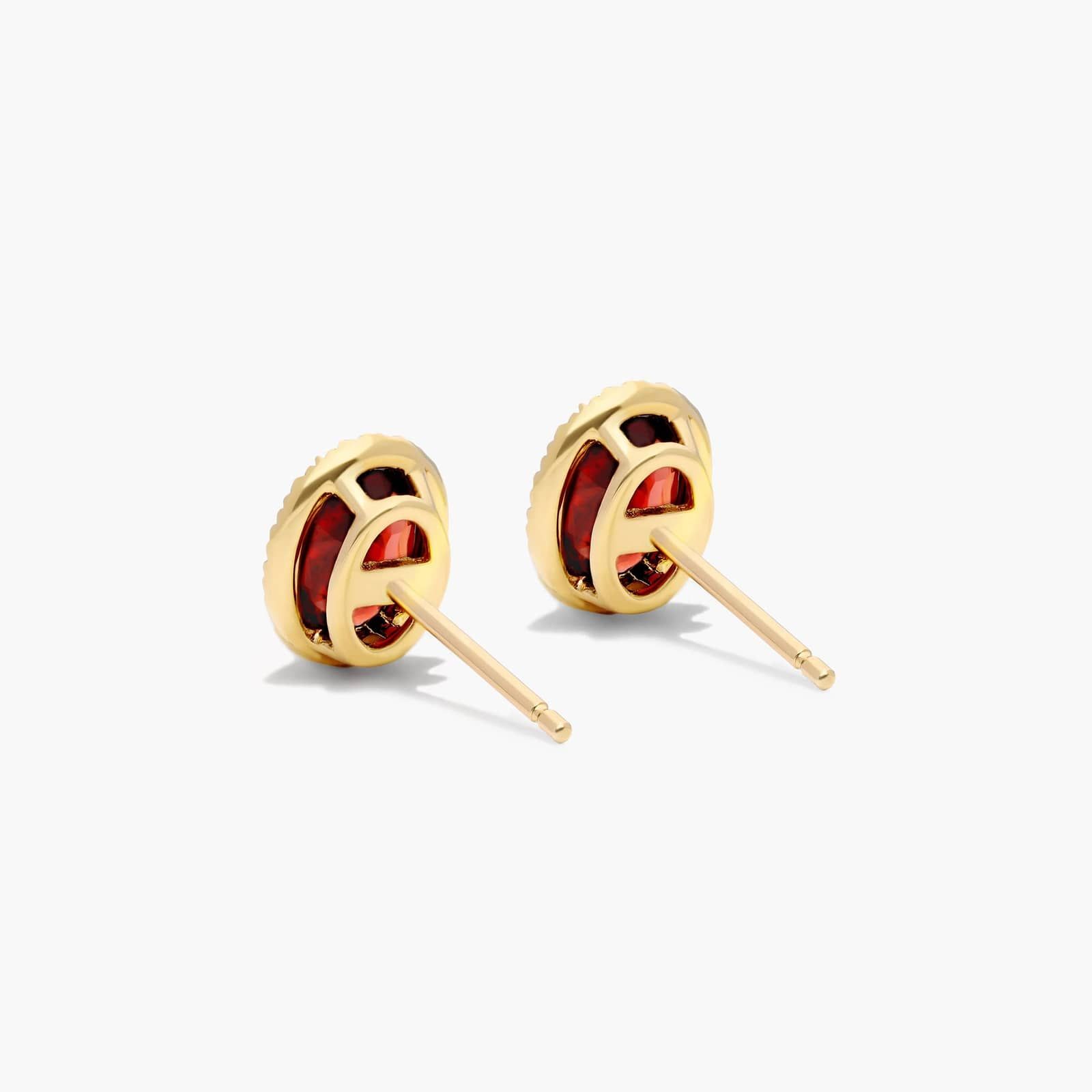 Oval Cut Garnet And Diamond Halo Stud Earrings In 14K Yellow Gold