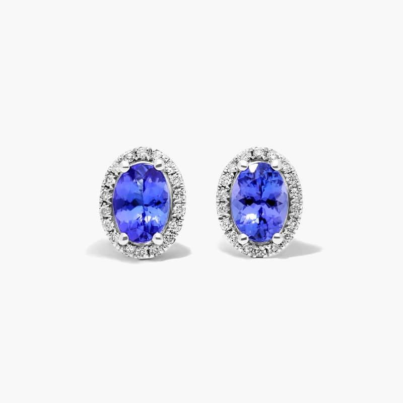 Oval Cut Tanzanite And Diamond Halo Stud Earrings In 14K White Gold