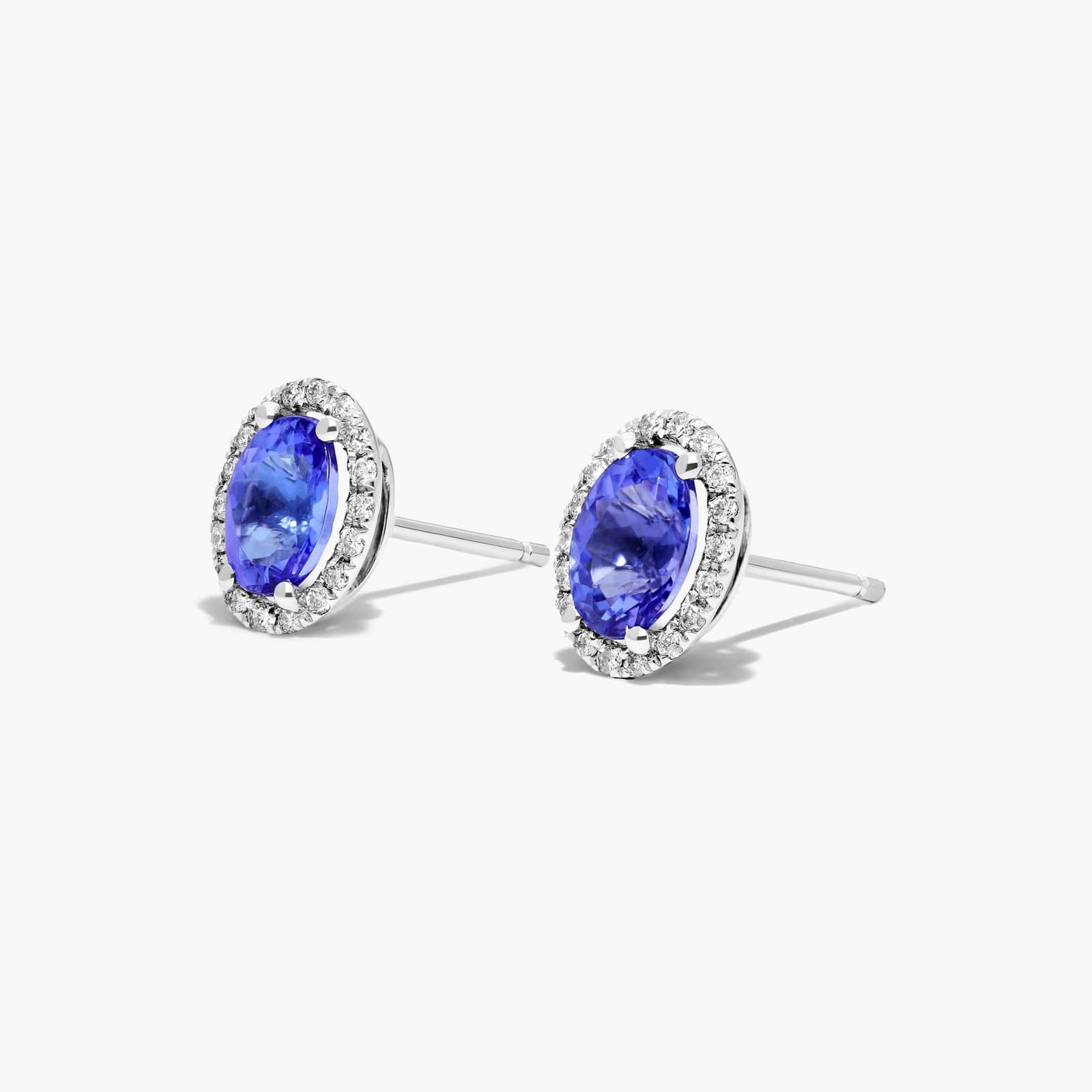 Oval Cut Tanzanite And Diamond Halo Stud Earrings In 14K White Gold
