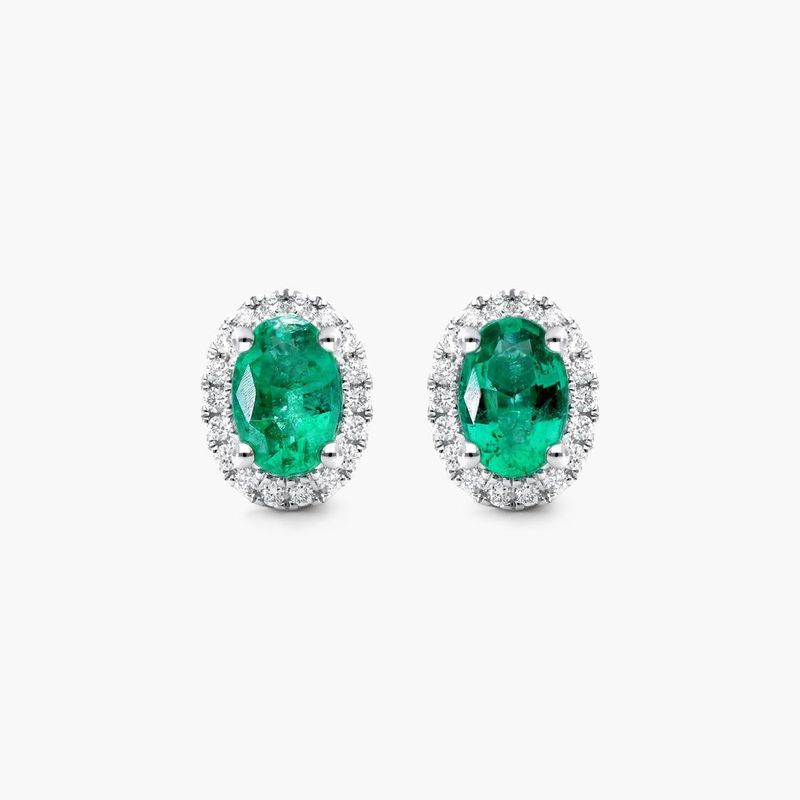 Oval Cut Emerald And Diamond Halo Earrings In 18K White Gold