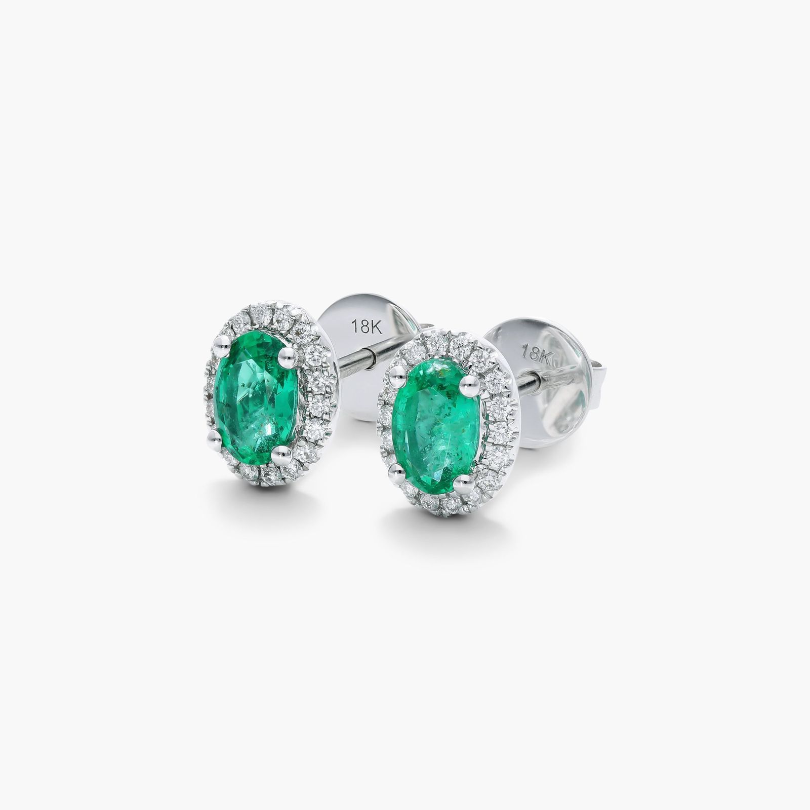 Oval Cut Emerald And Diamond Halo Earrings In 18K White Gold