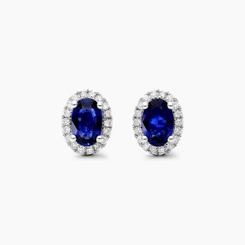 Oval Cut Sapphire And Diamond Halo Earrings In 18K White Gold